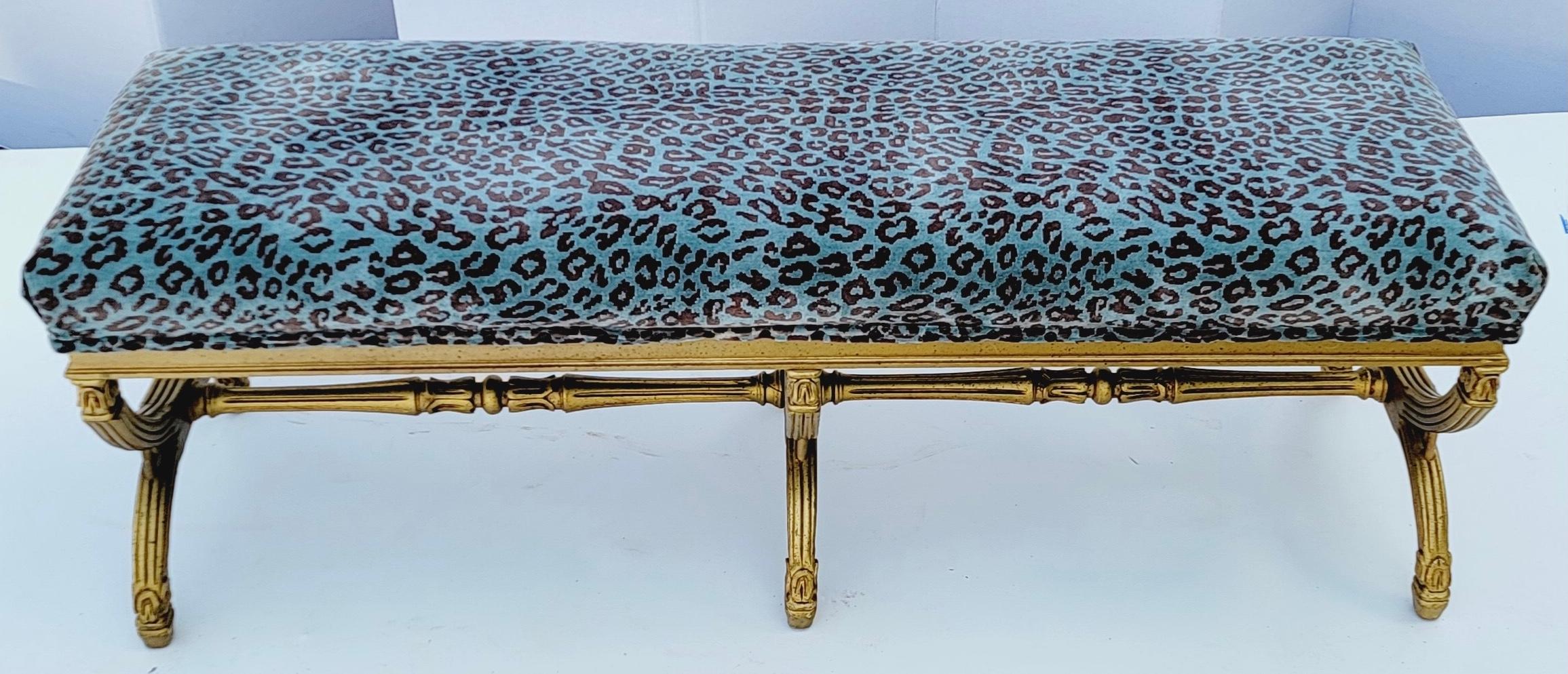 This is a long neo-classical style Italian giltwood bench in a turquoise leopard velvet. It dates is a mid-century piece and is Italian. The upholstery is recent and is in very good condition.