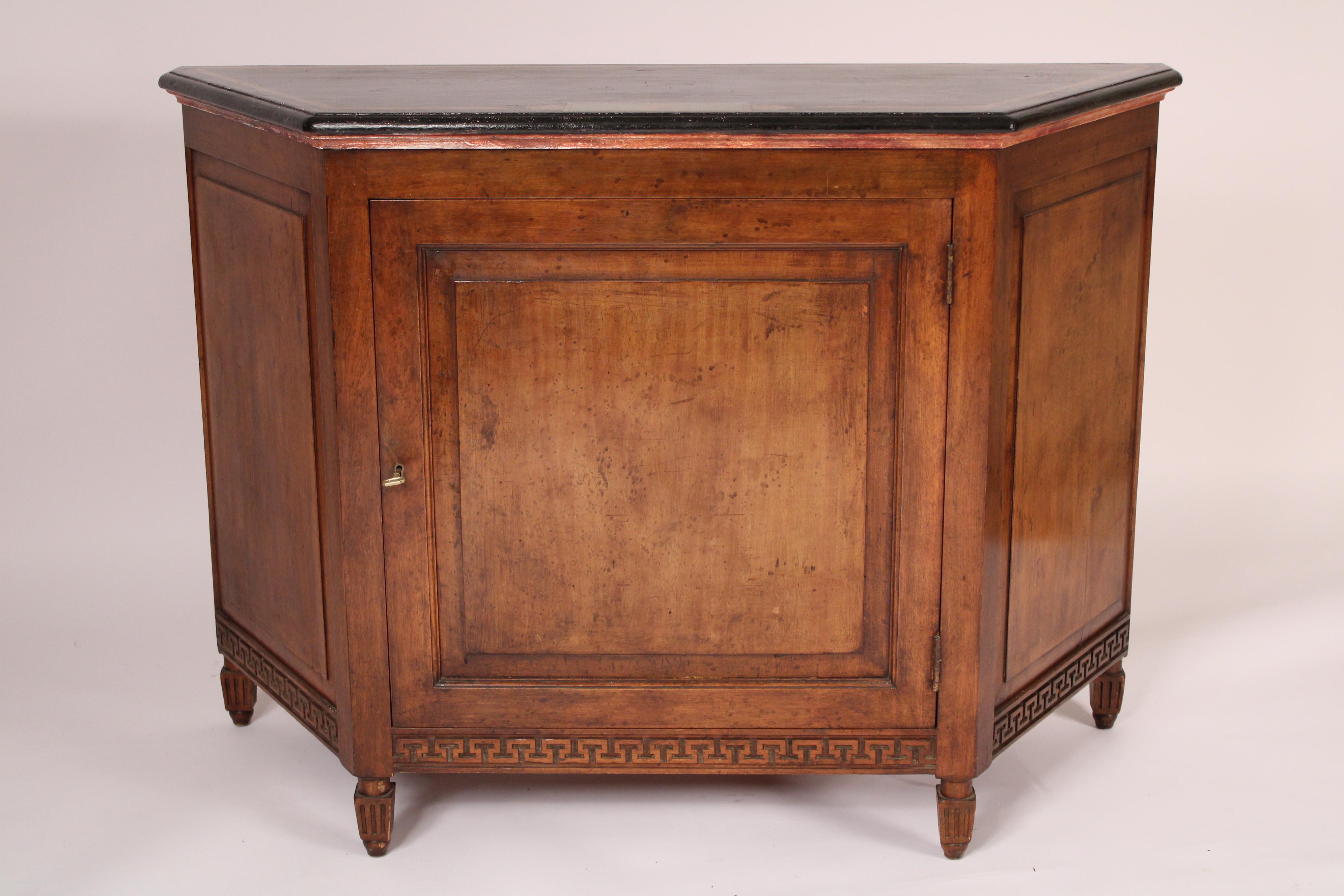 Neo classical style mahogany cabinet with a painted top, circa 1930's. With a painted top over a paneled door and paneled sides, the apron with Greek key design, resting on petite square tapered fluted legs. The mahogany has excellent color. 