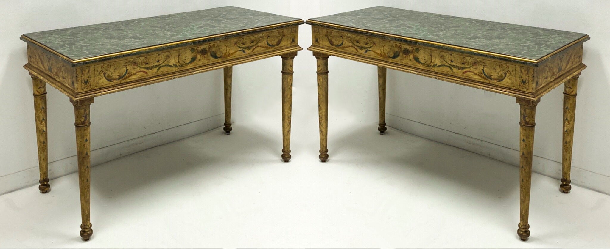 This is a pair of tasselated marble top console tables with French neo-classical styling. They are hand painted and were hand crafted by Maitlandd-Smith. They are in very good condition. Great size with continental styling!