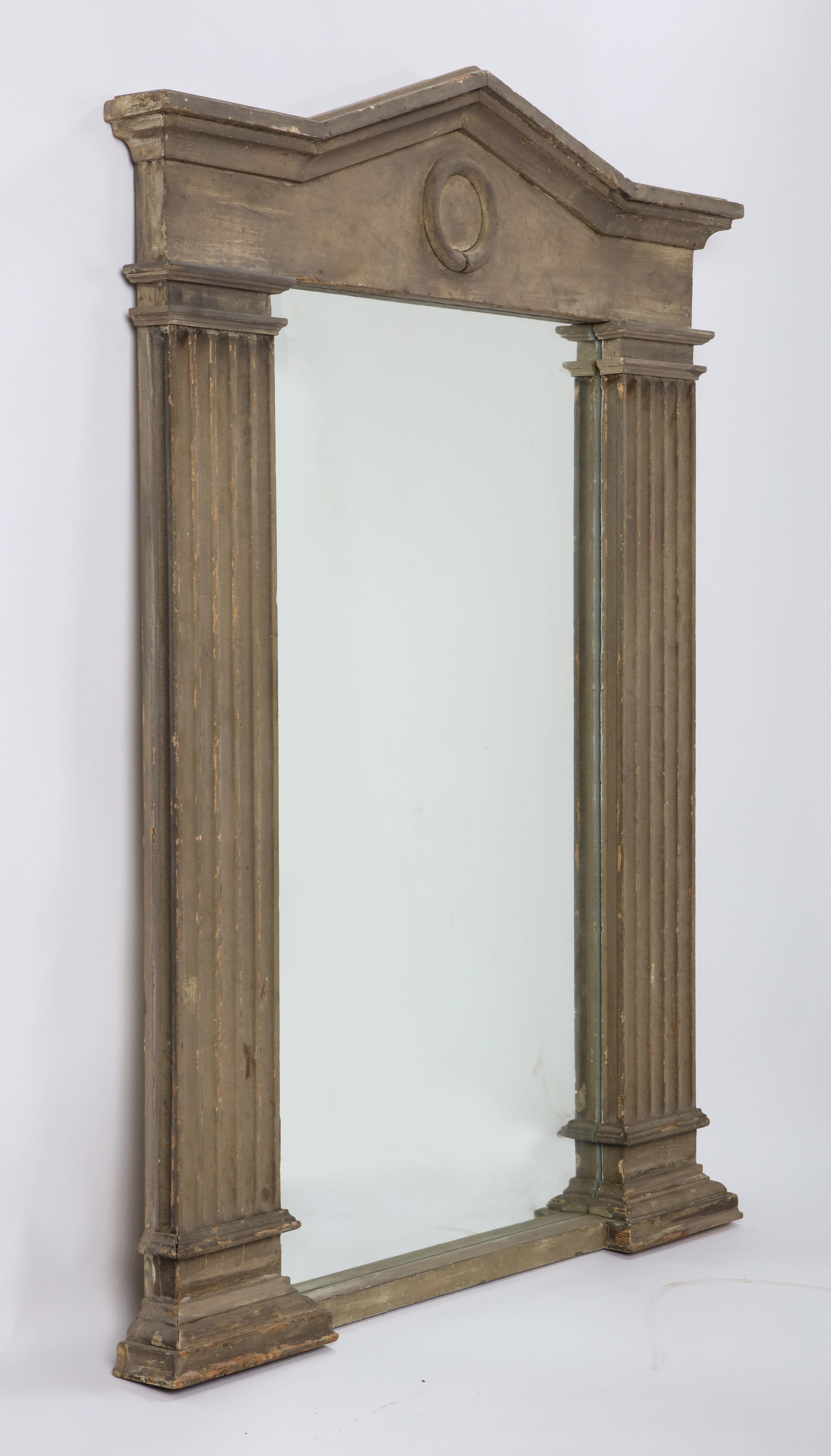 This Modern Neoclassical style mirror brings a little taste of the past to a contemporary audience. Evoking stylistic cues of antiquity— an arched pediment, fluted columns — this rectangular mirror will fit any Classics lover's needs. The soft dove