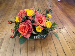 Neo-Classical style silver plated rectangular planter with silk flowers.