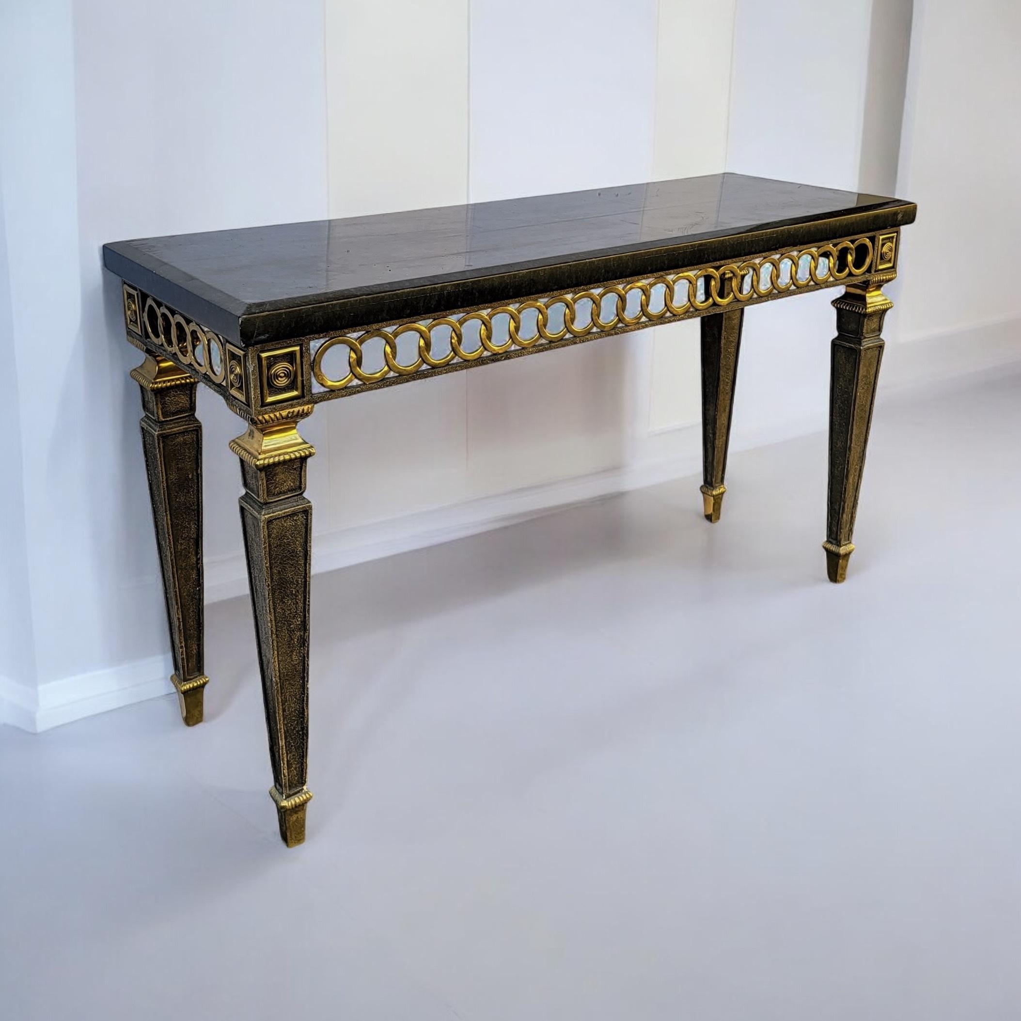 This is a striking neo-classical style console table with tessellated marble top and a brass concentric circle apron. It is in very good condition and is attributed to Maitland-Smith.

Shipping is running two to five weeks. If your destination