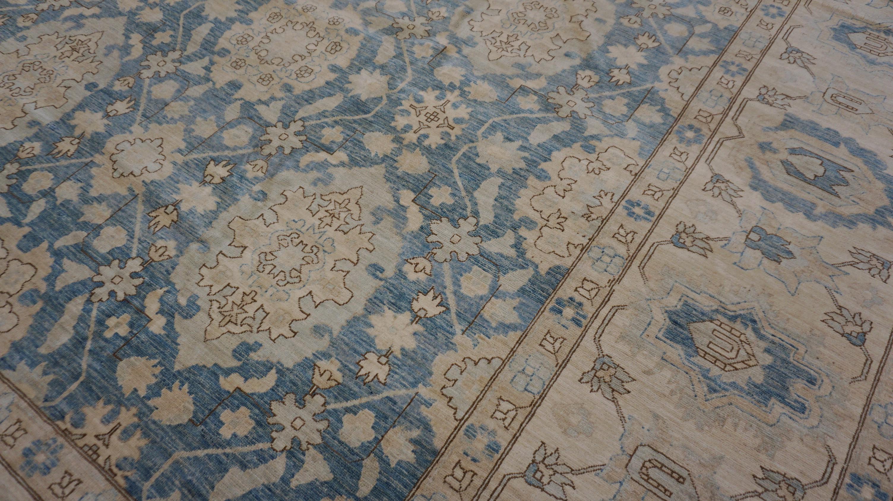 This stunning hand-knotted wool rug from is a beautiful example of traditional design reimagined in a refreshing soft blue, tan and ivory palette. Crafted by skilled artisans using premium hand-spun wool, the rug features an intricate all-over