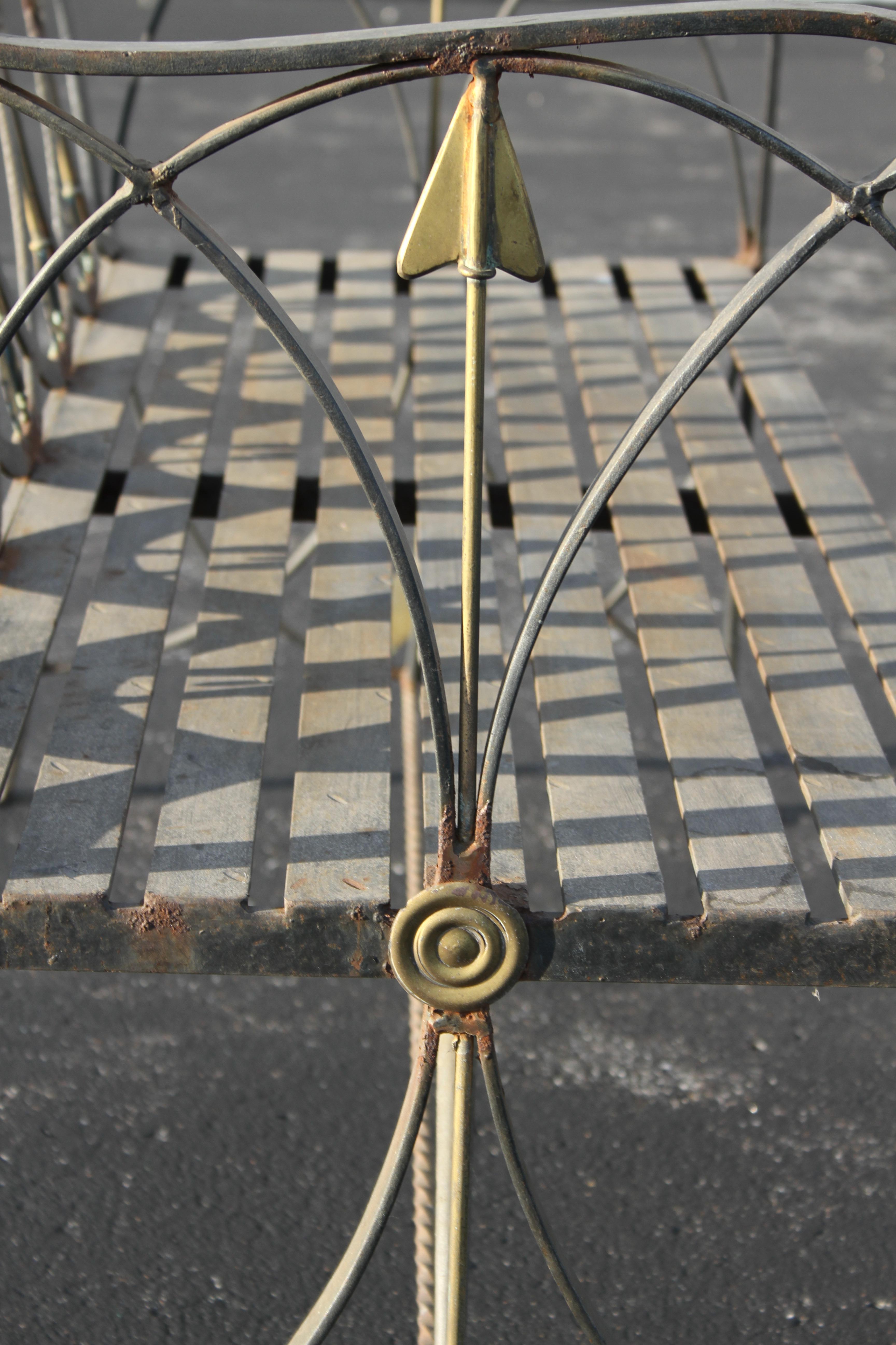 Unique stylized heavy wrought iron black garden bench or settee with ovals and scroll work, in the neoclassical style with Italian influence of Gio Ponti style gold Arrows and concentric circles. Solid wrought iron seat, with hammered details.