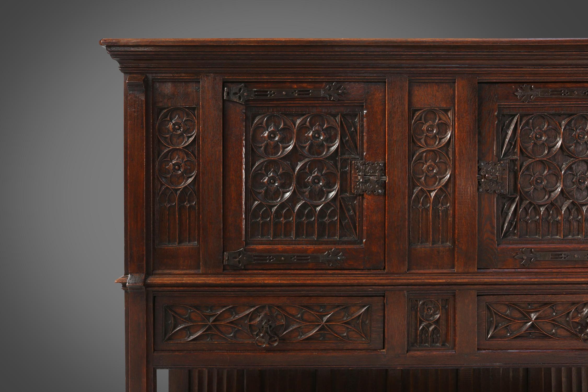 Hand-Carved Neo-gothic cabinet in oak with rich decorations and hidden storage, France, 1850 For Sale