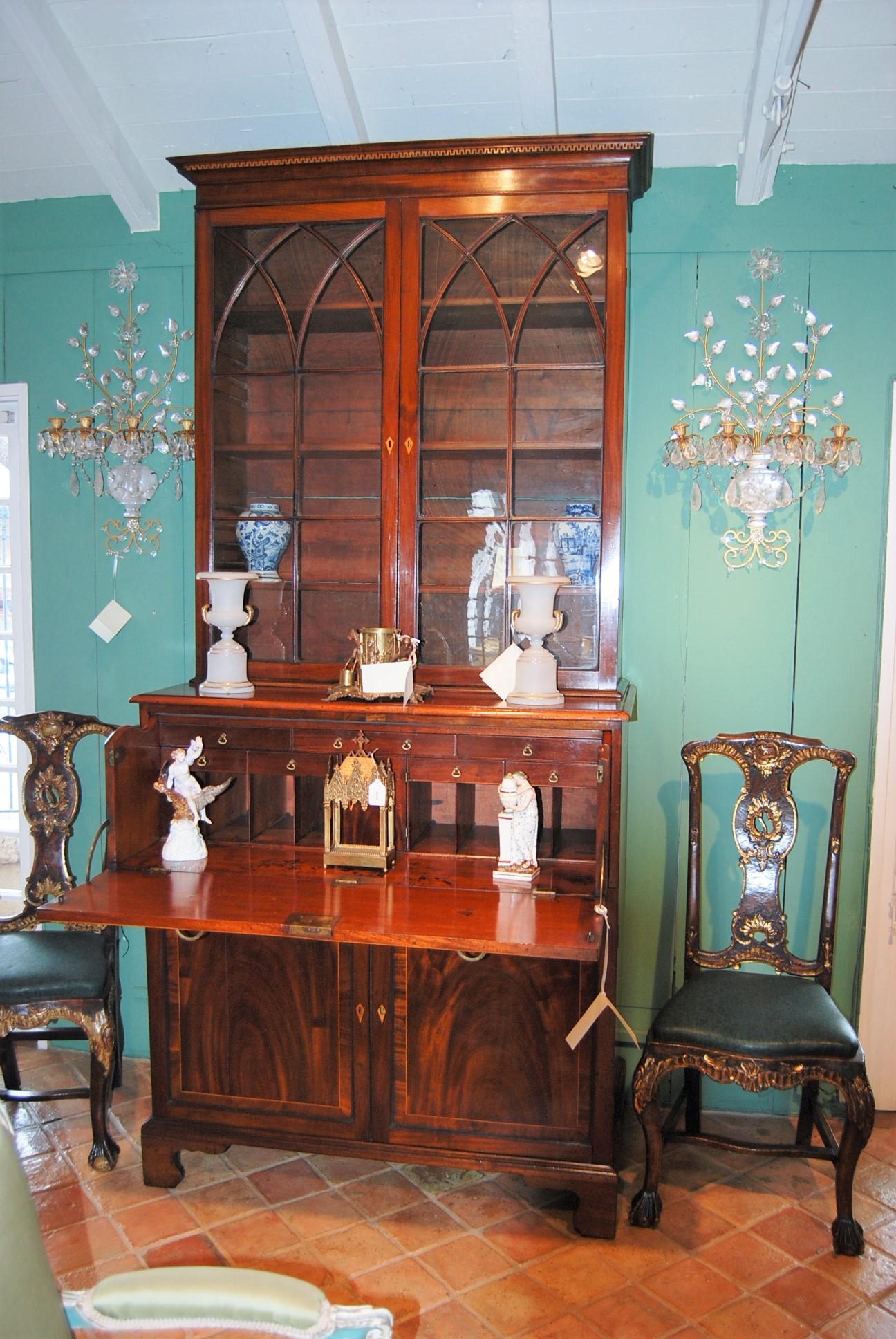 Make sure when you see sale price to take advantage of it, it will not be extended. 
English Regency inlaid mahogany secretary Upper hinged glass bookcase revealing three interior shelves, fall front desk and resting on a carved original bracket
