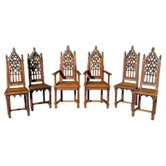 Set neogotico, 2 poltrone e 4 sedie intagliate, XIX secolo