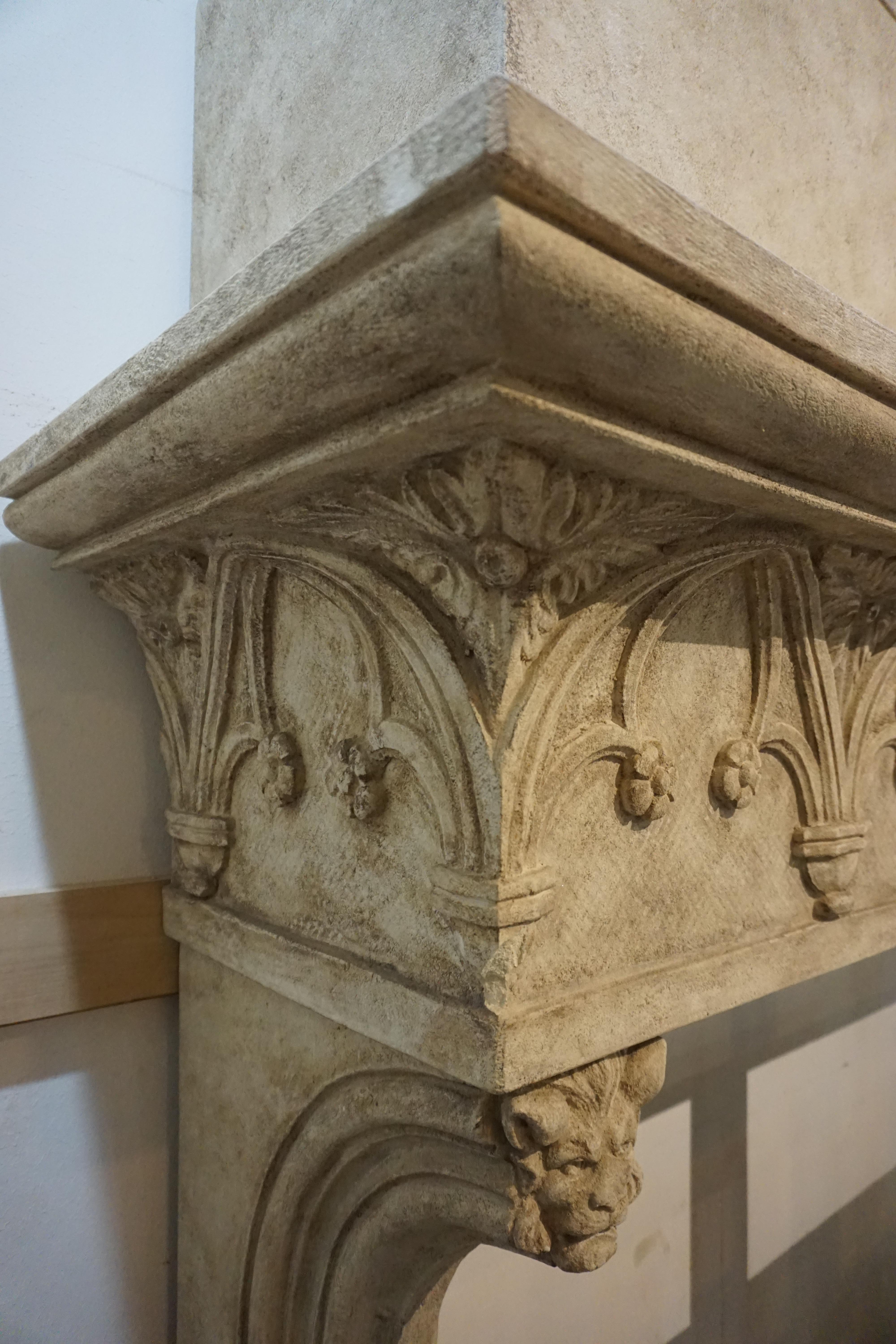 Designed and created in France, this contemporary Neo-Gothic style fireplace with hood was the perfect solution for a high-rise resident who desired the look and feel of real stone in a building with weight restrictions. Sculpted from light weight