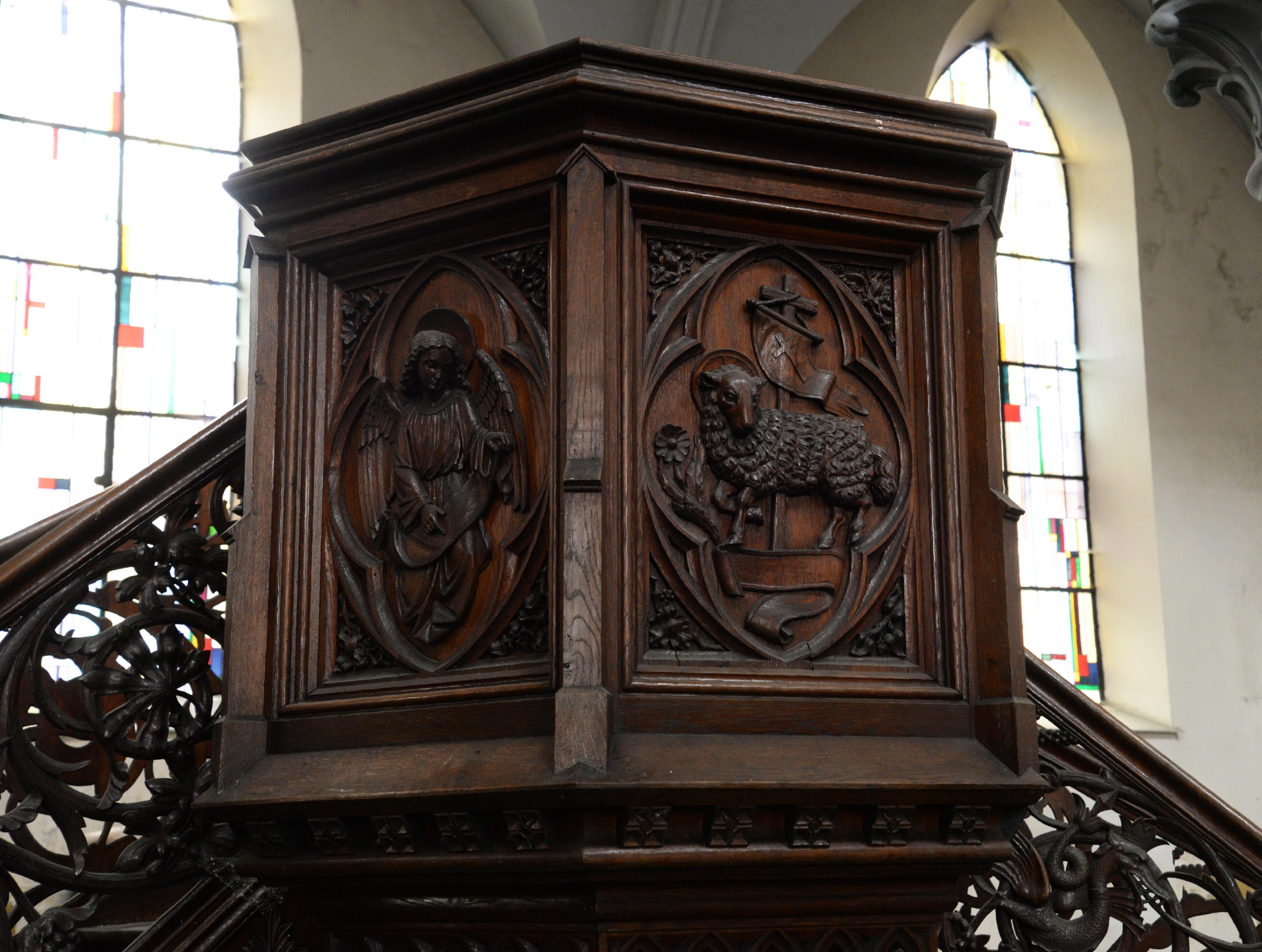 Pulpit in oak with double flight of stairs richly carved with monsters.