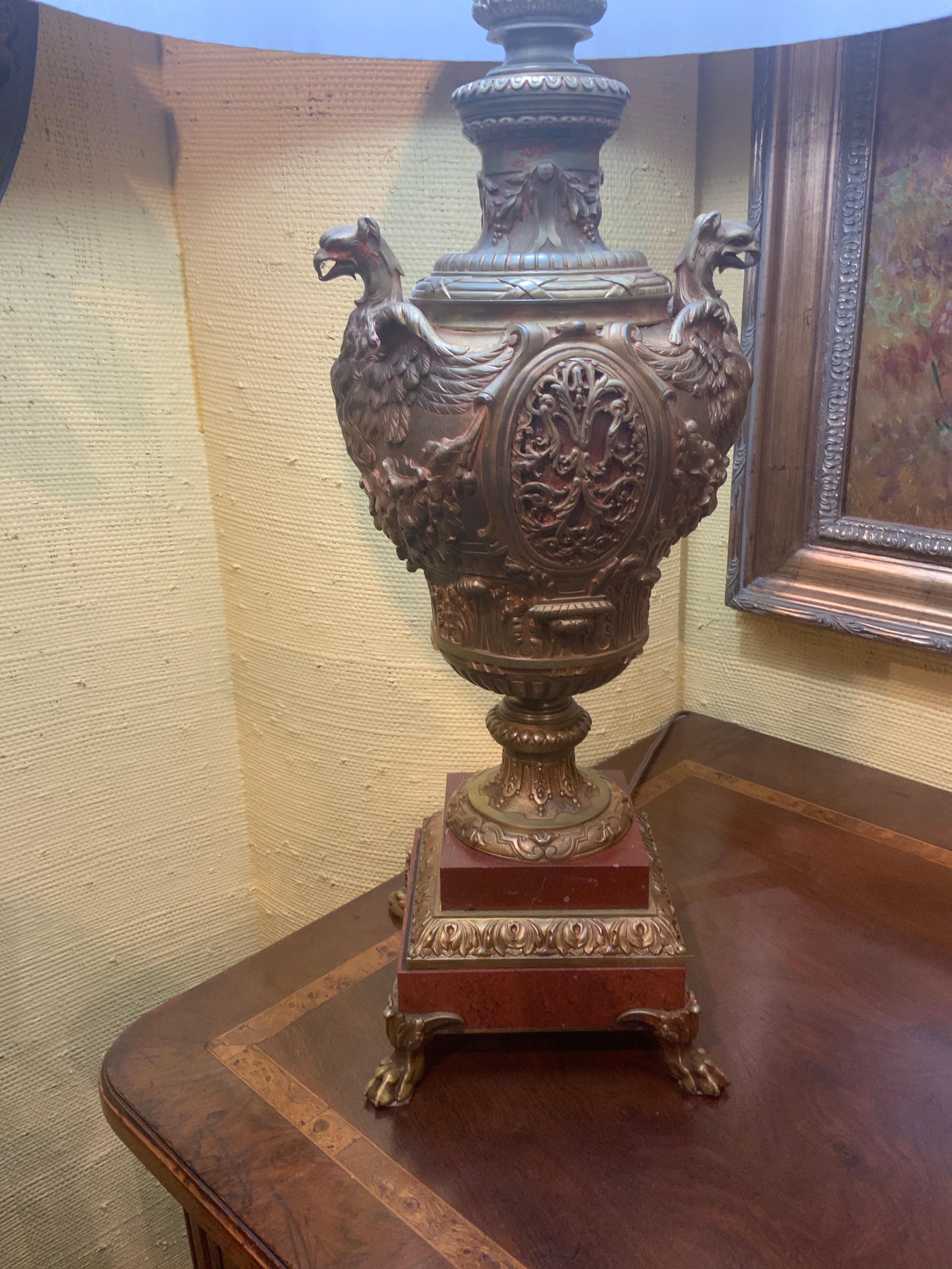 Handsome antique urn that has been converted to a
lamp. The bronze has patinated beautifully. Fine bronze work
And sits beautifully on a rouge marble base.