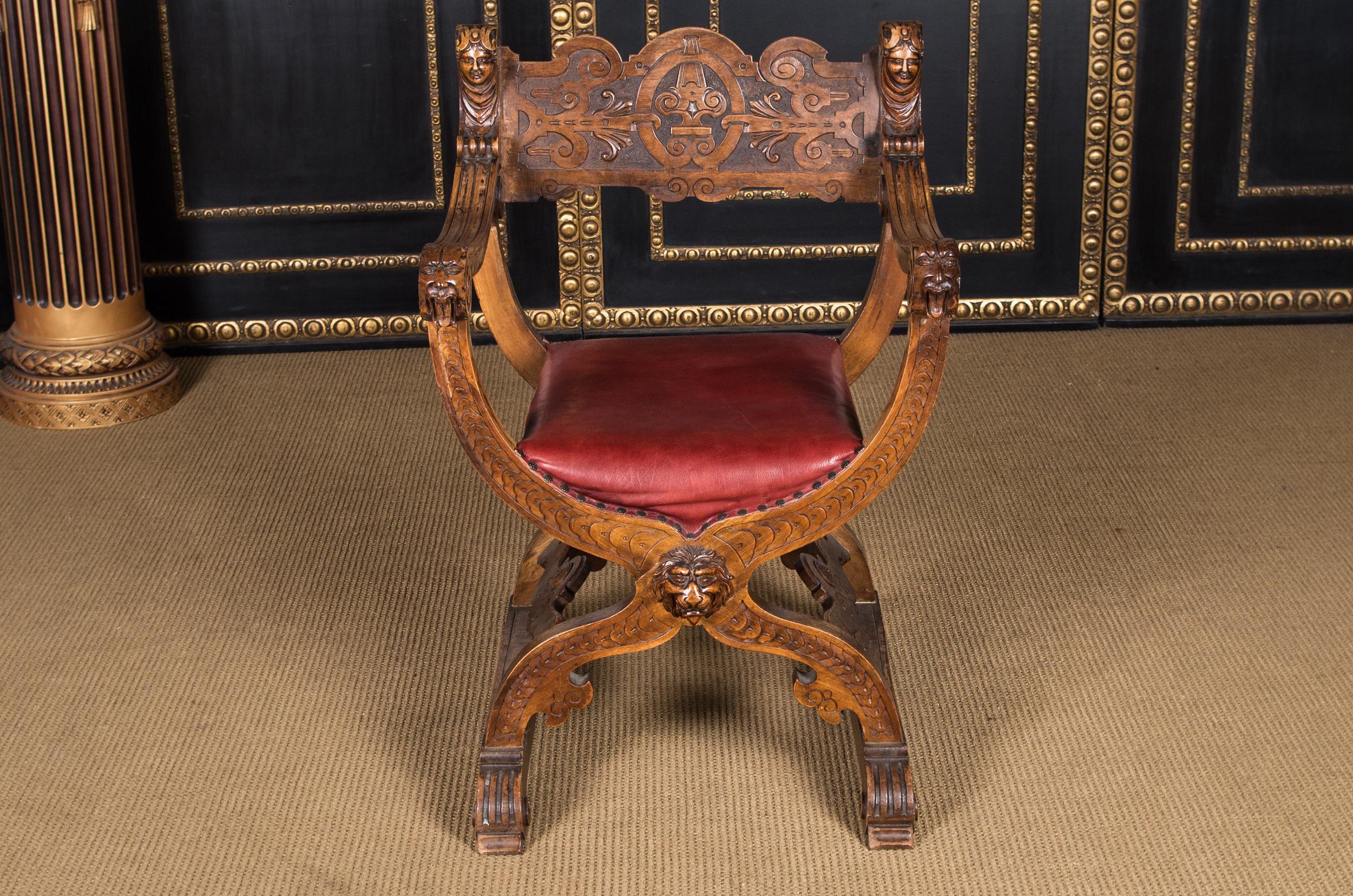Highly interesting Neo Renaissance scissors armchair, circa 1870-1880

Solid walnut. On four curved legs in scissors shape. Completely carved, flanked by two carved armrests. Seat upholstered with red leather, backrest with carvings.
