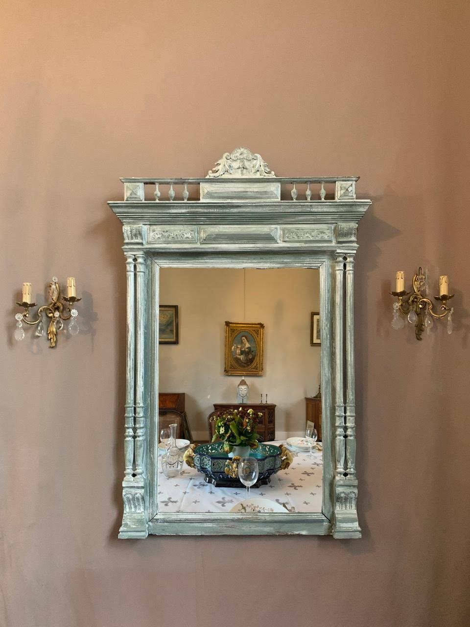 Large ornamental mirror in the Neo-Renaissance style, Henri II. This mirror has been patinated in grey and white. 

Mirror with double columns on each side with pedestal. It is a mercury mirror. 
The pediment at the top is composed of acanthus