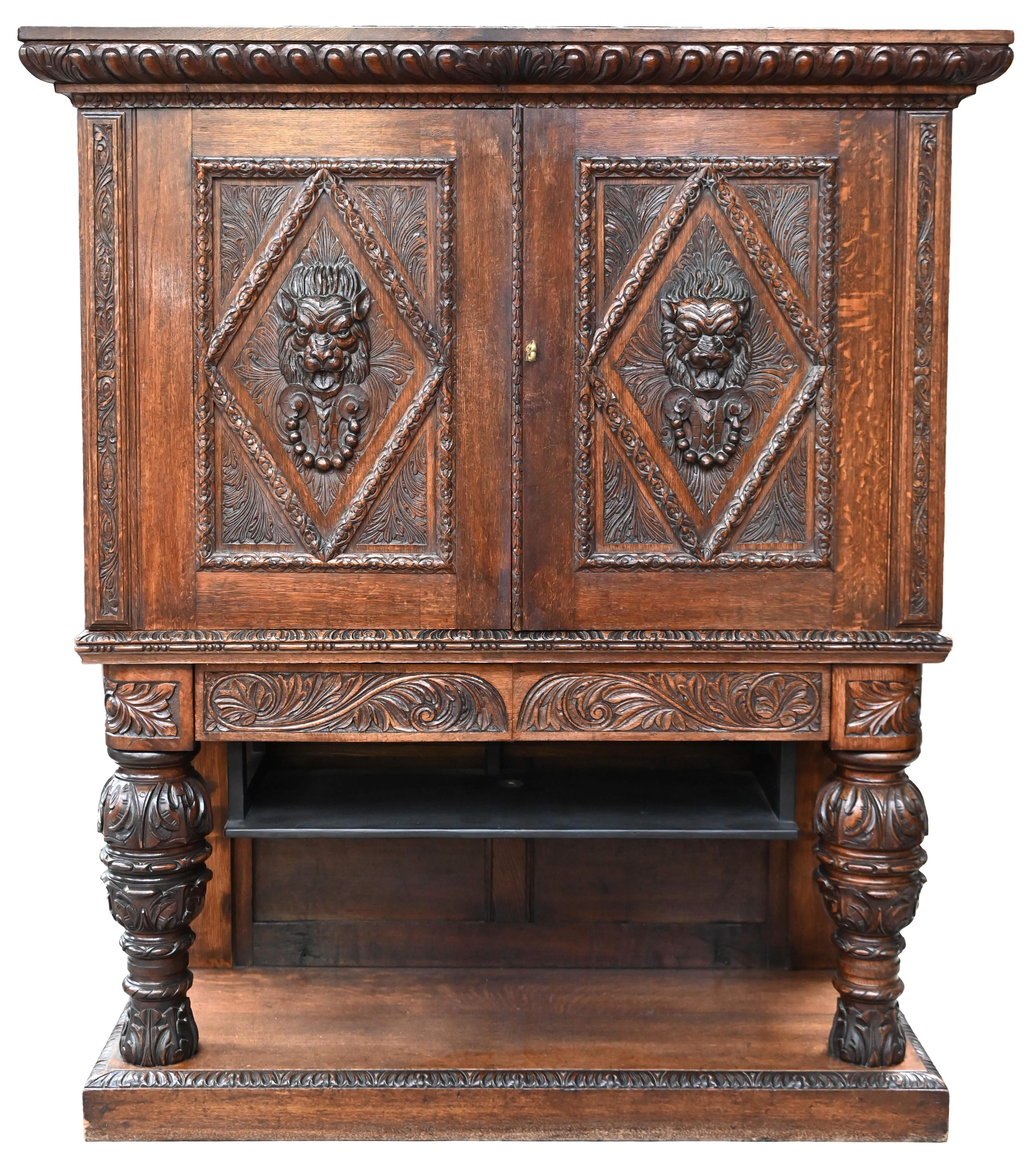 Neo-Renaissance oak cabinet with lion heads

Solid oak cabinet carved in Renaissance style. Rich carving runs all over the front and is dominated by two lion heads and massive ball feet. The cabinet is a two-door design with a pair of central