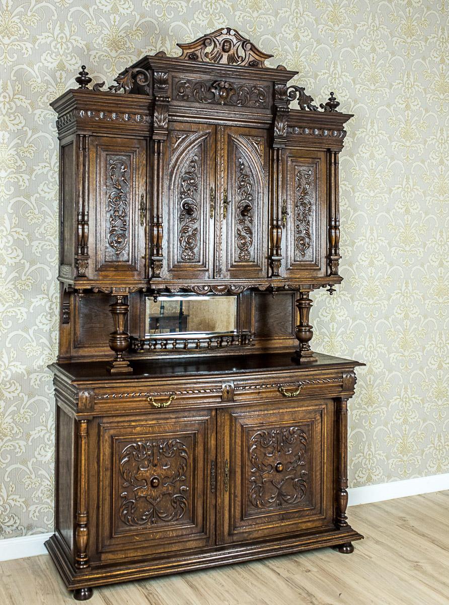 We present you this grand neo-Renaissance piece of furniture made of solid oakwood, circa 1890.
The cupboard is composed of a two-door base with an advanced socle cornice, and a three-door upper section, which is topped with a crowning cornice with