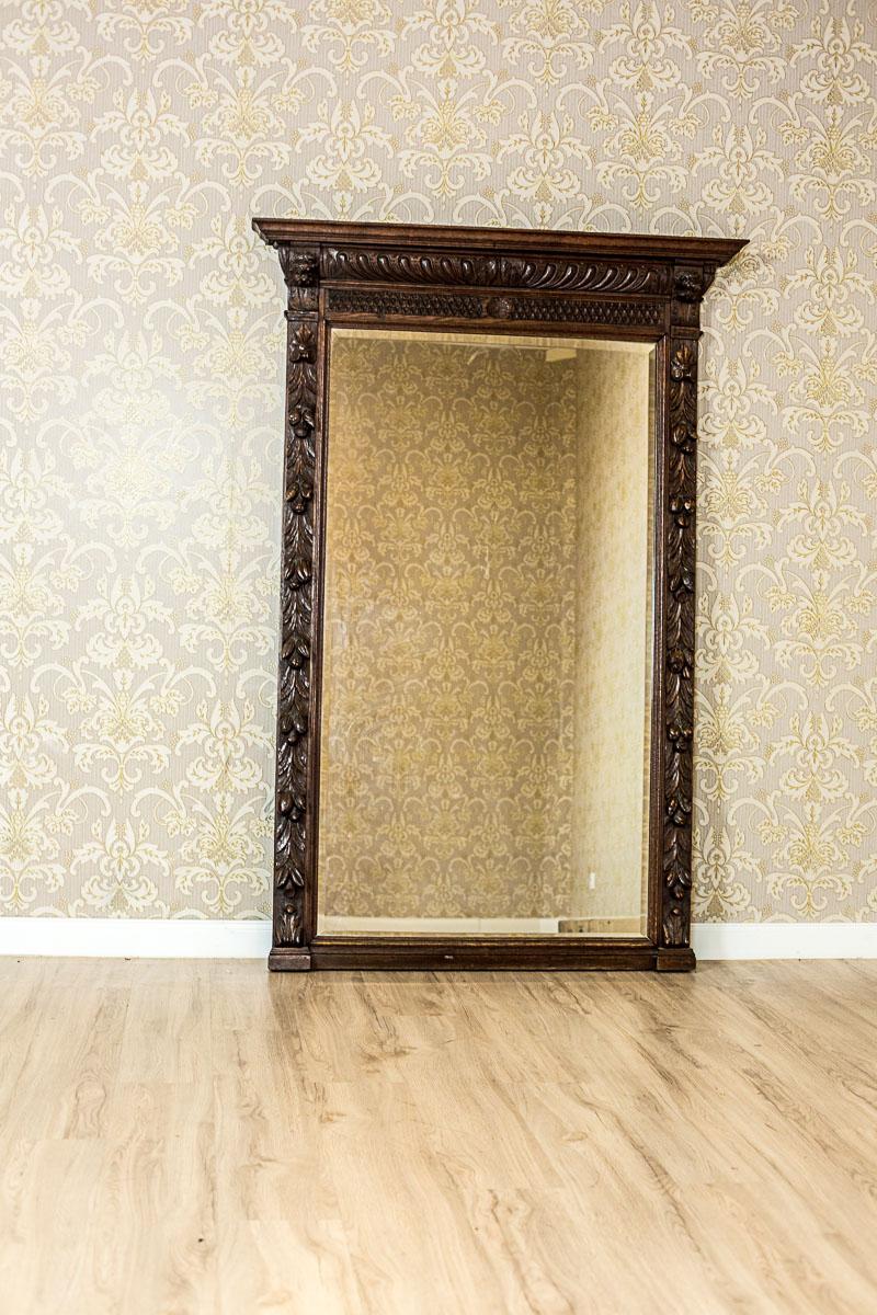 We present you this pier glass, circa 1880, of monumental size.
The frame is made of solid oak wood.
Furthermore, the mirror is flanked by pilasters with a semi-plastic ornament with a floral-fruit motif, and topped with a simple cornice made of