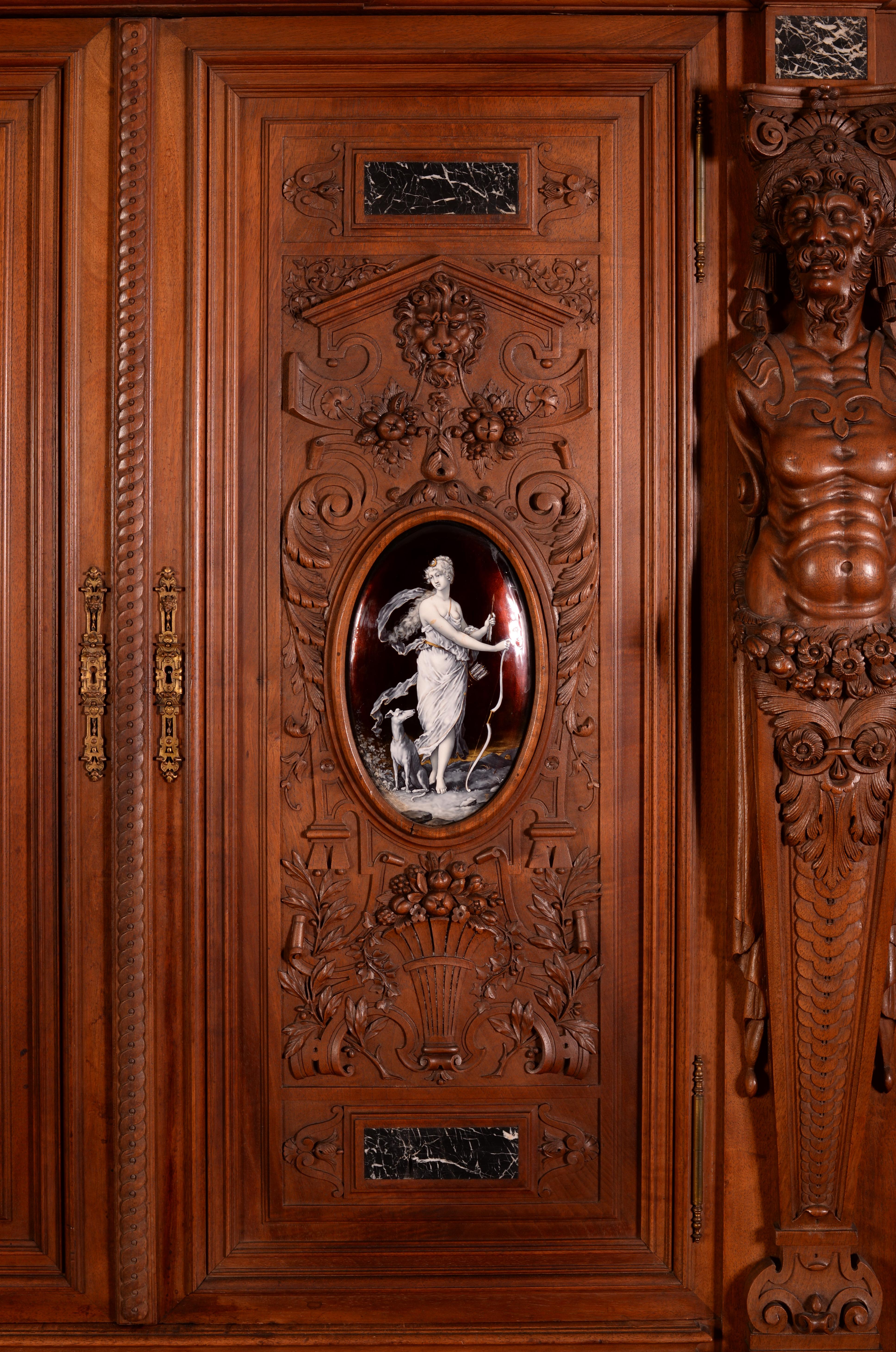 This two-bodies Neo-Renaissance style display cabinet with two glass doors was made in the second half of the nineteenth century in waxed walnut. The enamel plates, remarkable in their execution, are signed with the initials of Theophile Soyer