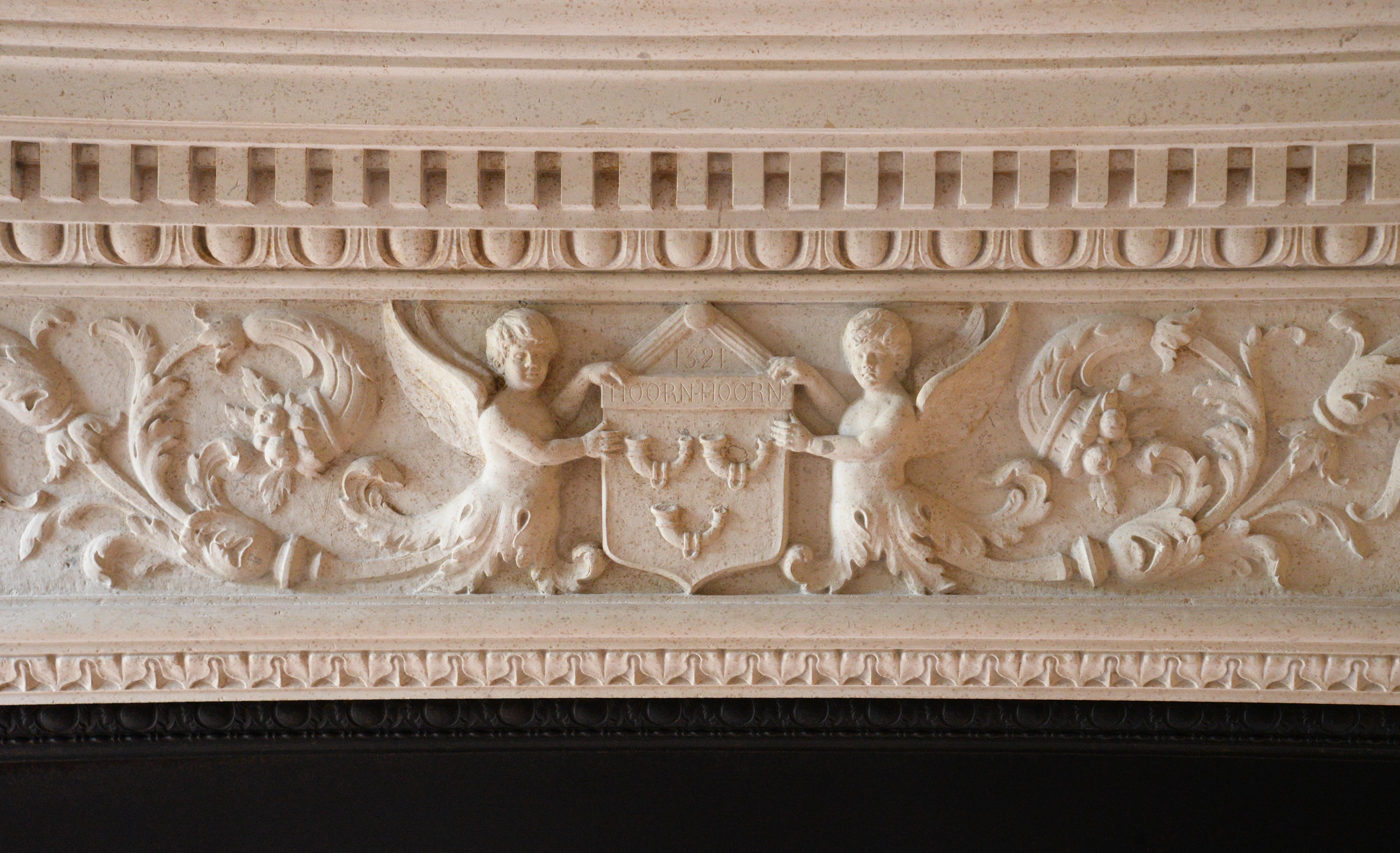 This monumental fireplace was carved in stone around 1905 in a Neo-Renaissance style.
It is supported by two detached columns composed of two orders from the Roman antiquity, the Ionic order with the scrolls and the Corinthian order characterized