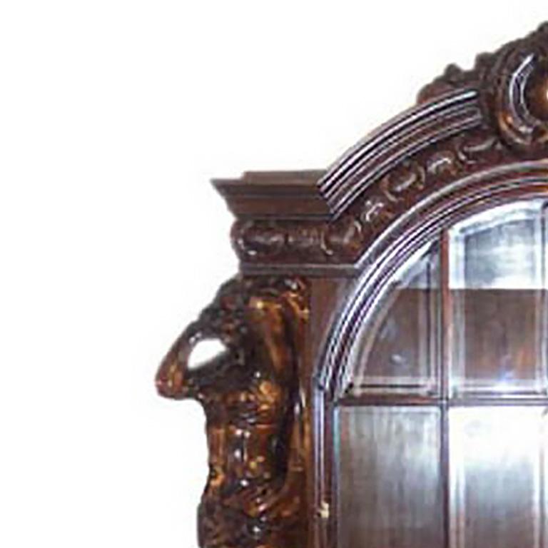 Solid oak, ornately carved. Large glass vitrine with interior shelves above 2 doors with interior shelves. Austro-Hungarian circa 1860/80. Part of suite with Buffet E11/18, Table E11/18-2, Chairs E11/18-3, Credenza E11/18-4.