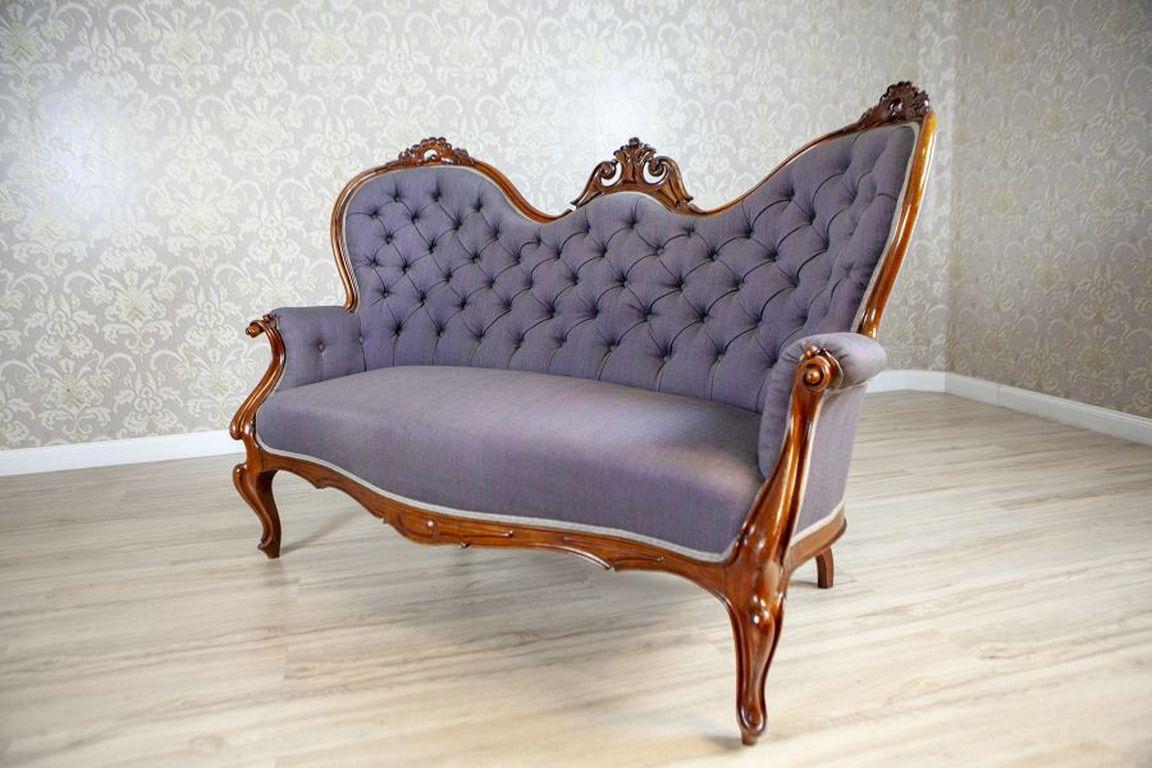 Rococo Revival Walnut Sofa Circa 1860 in Violet Upholstery

Wooden elements made of walnut wood. Spring seat, filled with sea grass. Decoratively tufted backrests. The furniture is in its original condition, requiring minor restoration; the