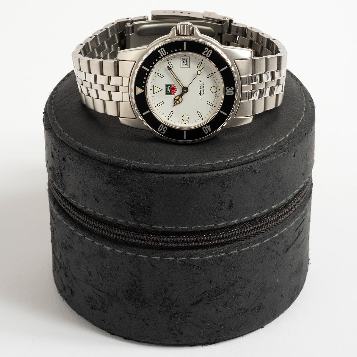 Our iconic, neo-vintage Tag Heuer 1500 series reference WD1213 features a white dial and black bezel with stainless steel 37mm case and bracelet. Presented in excellent condition with light signs of use overall, the dial and hands are original and