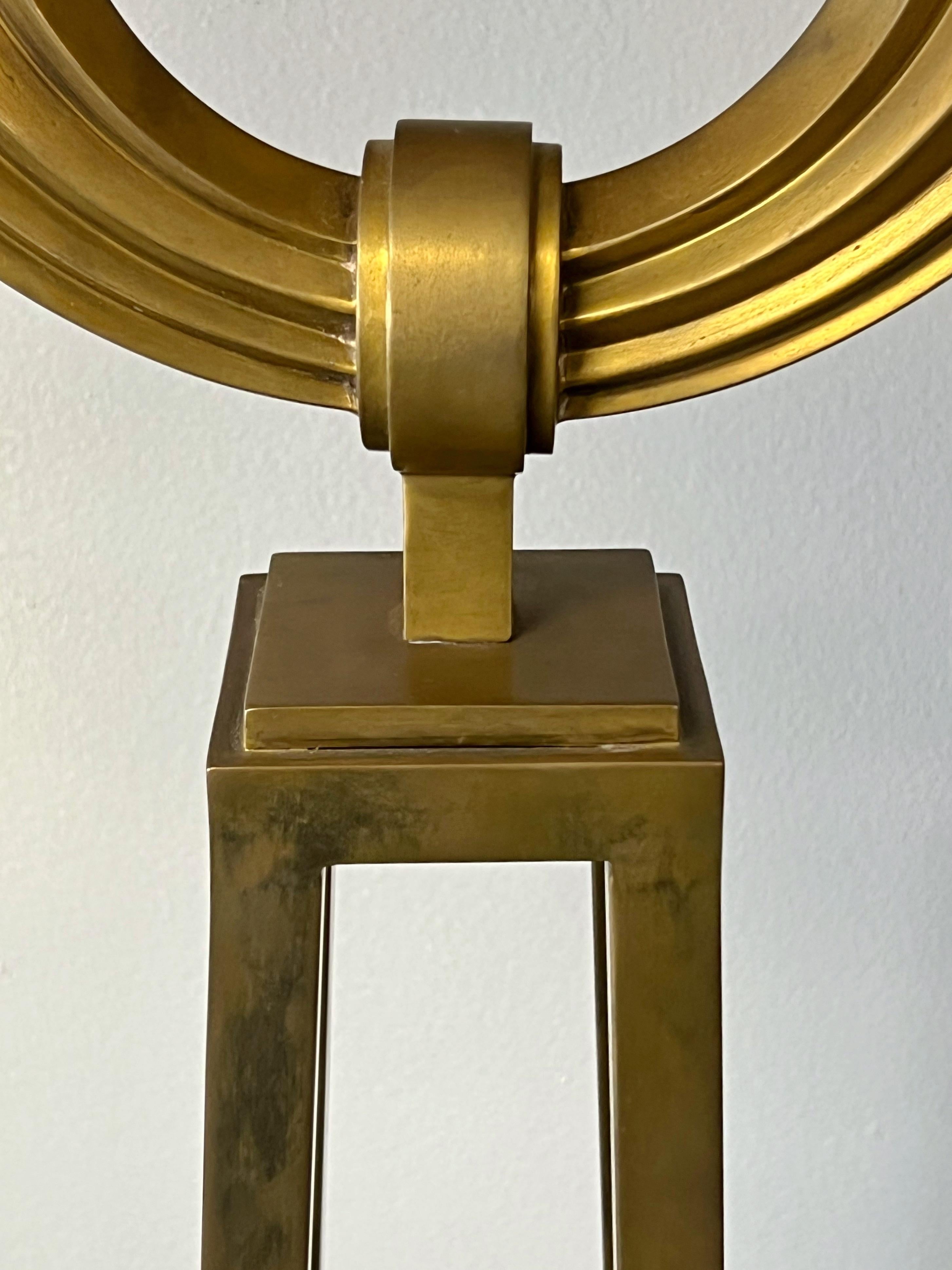 A brass floor lamp in the neoclassic style. Comes with a vintage shade with Greek key detail. Nice patina to brass. 3 way socket.