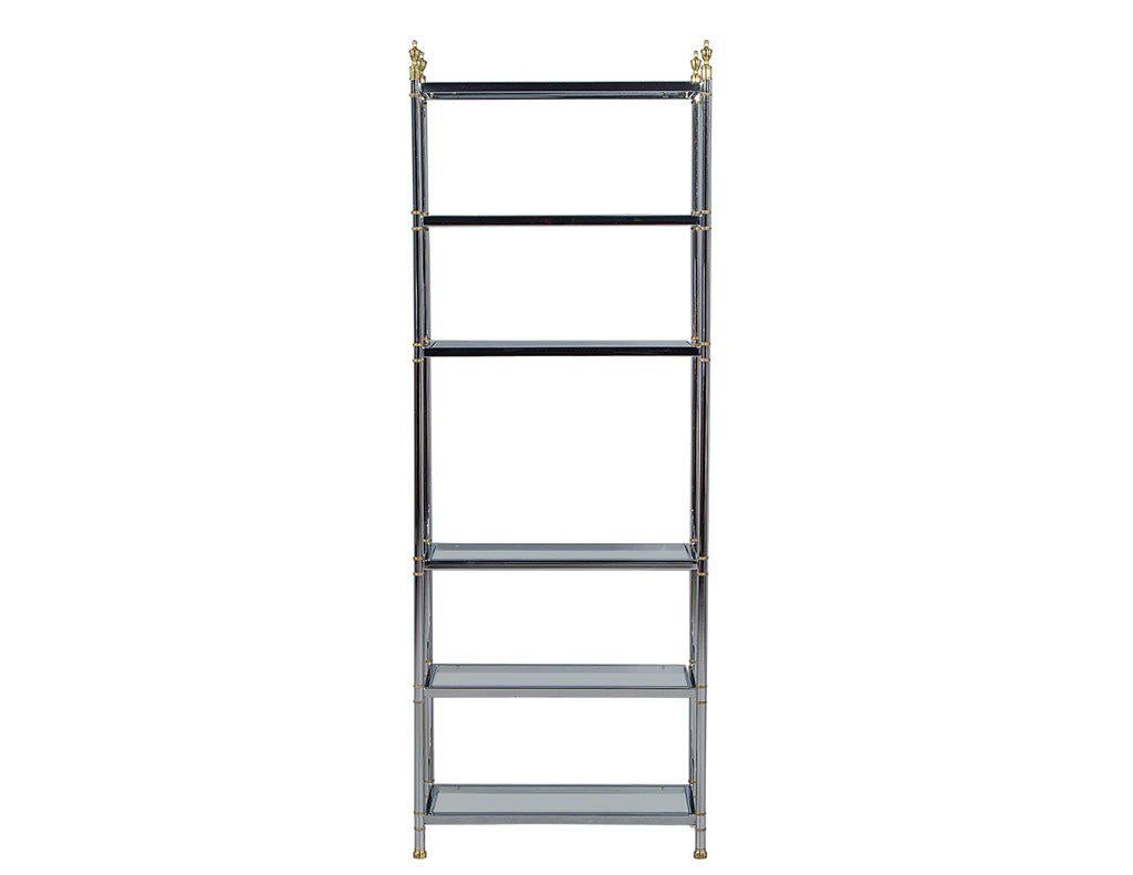 Bring some neoclassical glamour into your living space with this elegant étagère with six glass shelves for everything you might want to show off. A tubular chrome vertical structure with welded chrome frames and glass insets, is accented by brass