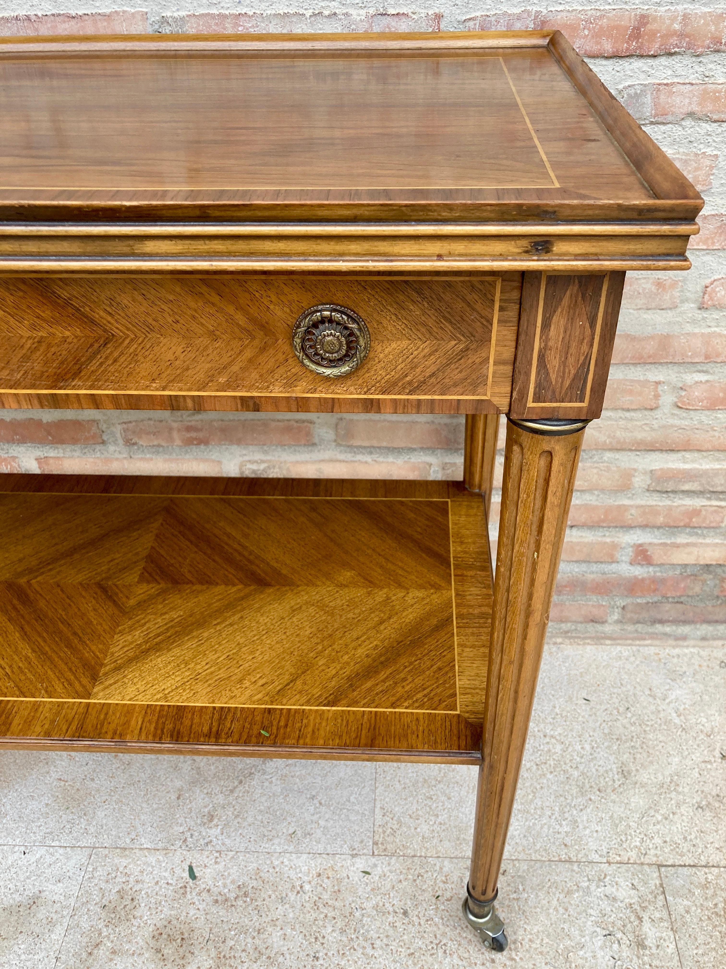 French Neoclassical Marquetry Side Table with One Drawer and Wheels. 
Beautiful Side Table with a drawer and an open shelf. 
It is comfortable to be easily transported around the room because its legs end with small wheels. 
Light wear consistent