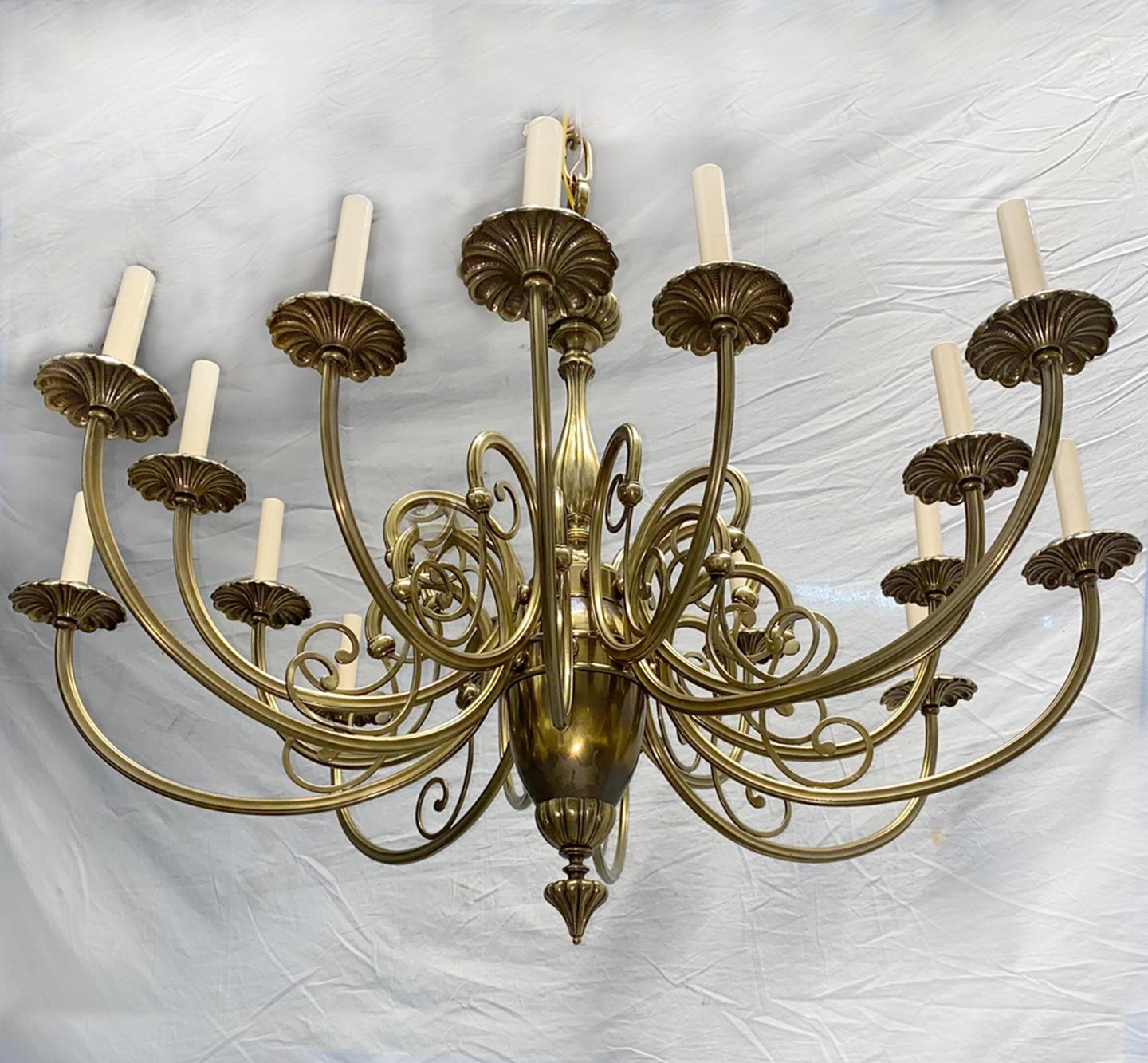 A circa 1950's French gilt bronze neoclassic style chandelier with scrolling arms and 16 lights.

Measurements:
Drop: 31