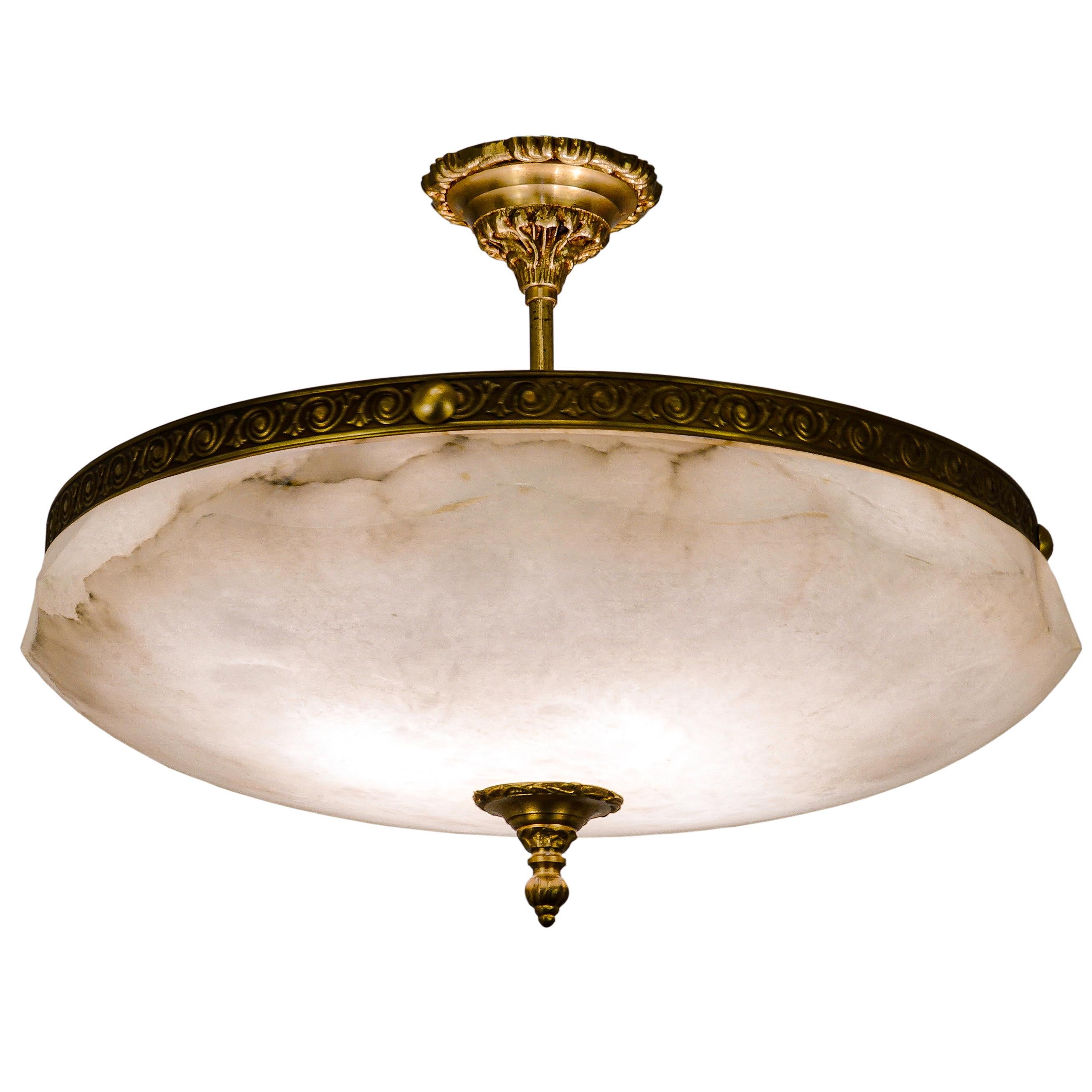 This elegant light may be mounted almost flush to the ceiling due to the central stem support and come complete with ceiling adapters for installation. An inward curving polygonal upper rim carved into bowl is neatly suspended by a gapless brass