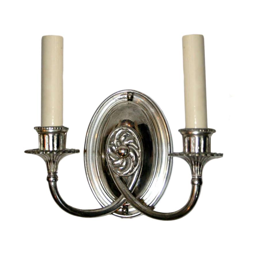 Pair of circa 1920s English silver plated double light sconces with rosette detail at center.
Measurements:
Height 8