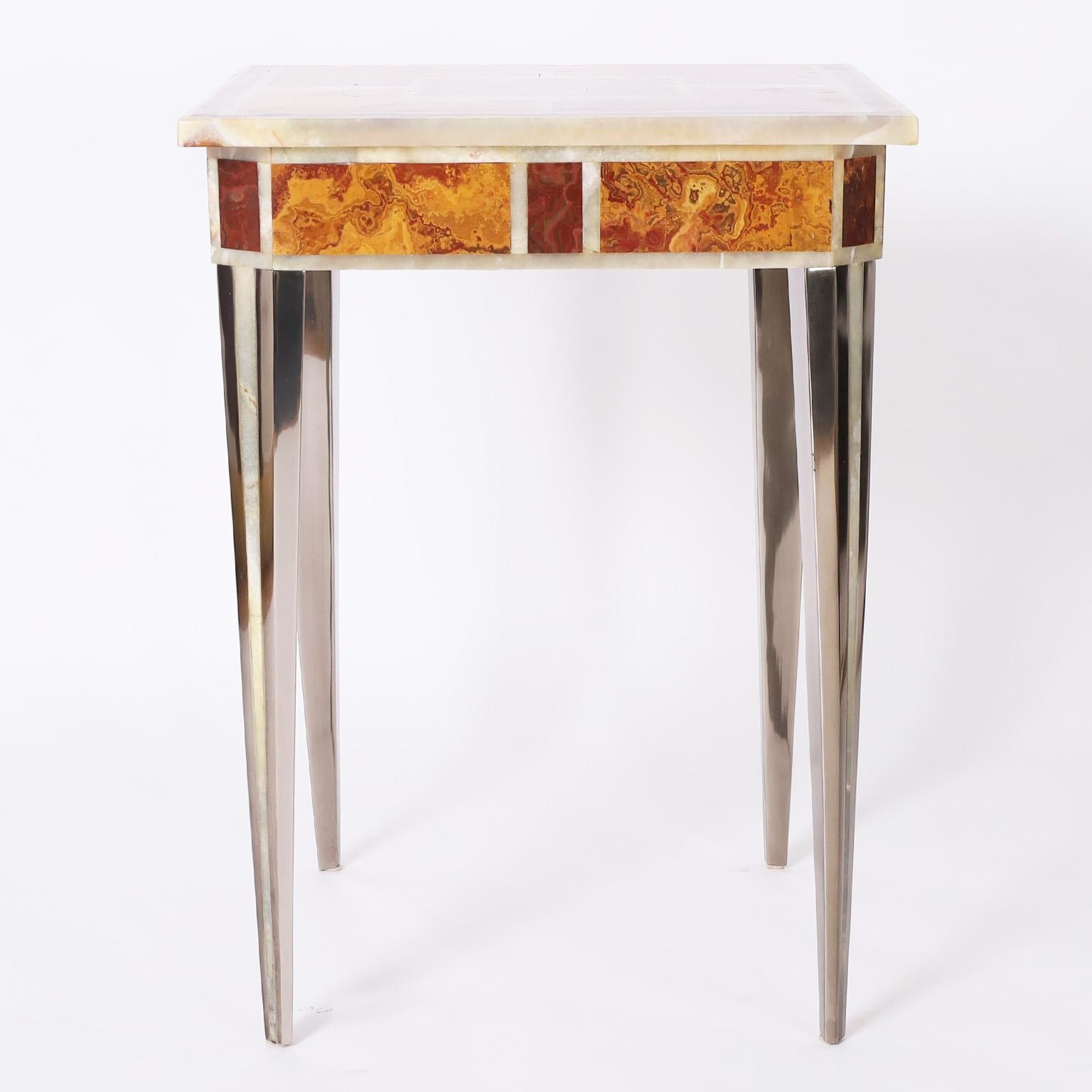 Impressive vintage occasional table having a square top with three types of marble divided by onyx borders. The elegant tapered metal legs have an onyx stripe.