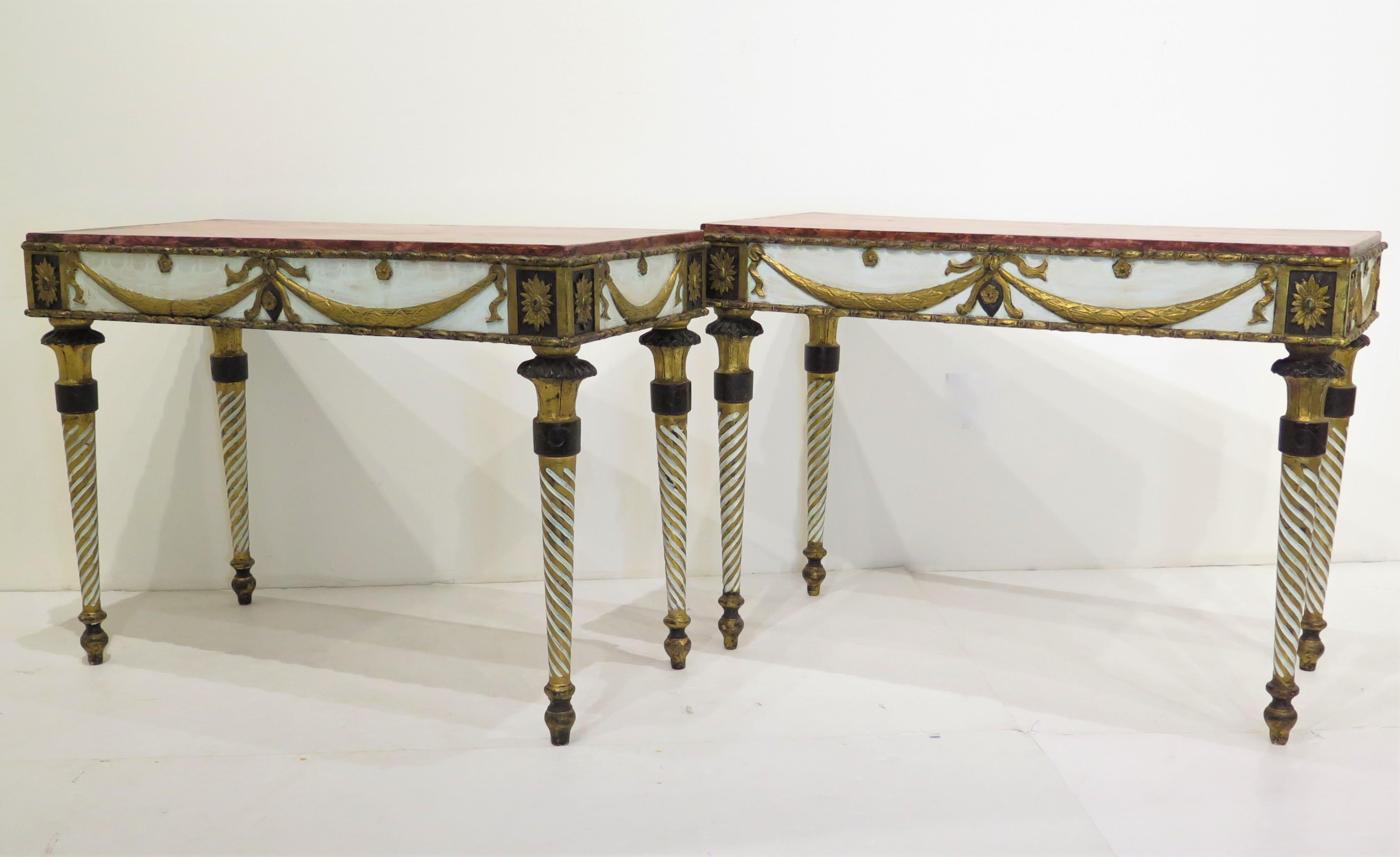 pair of Neoclassic-style console tables, polychromed and gilded wood with painted faux marble tops, gilt garland swags, spiral carved legs. Italy, circa 1875