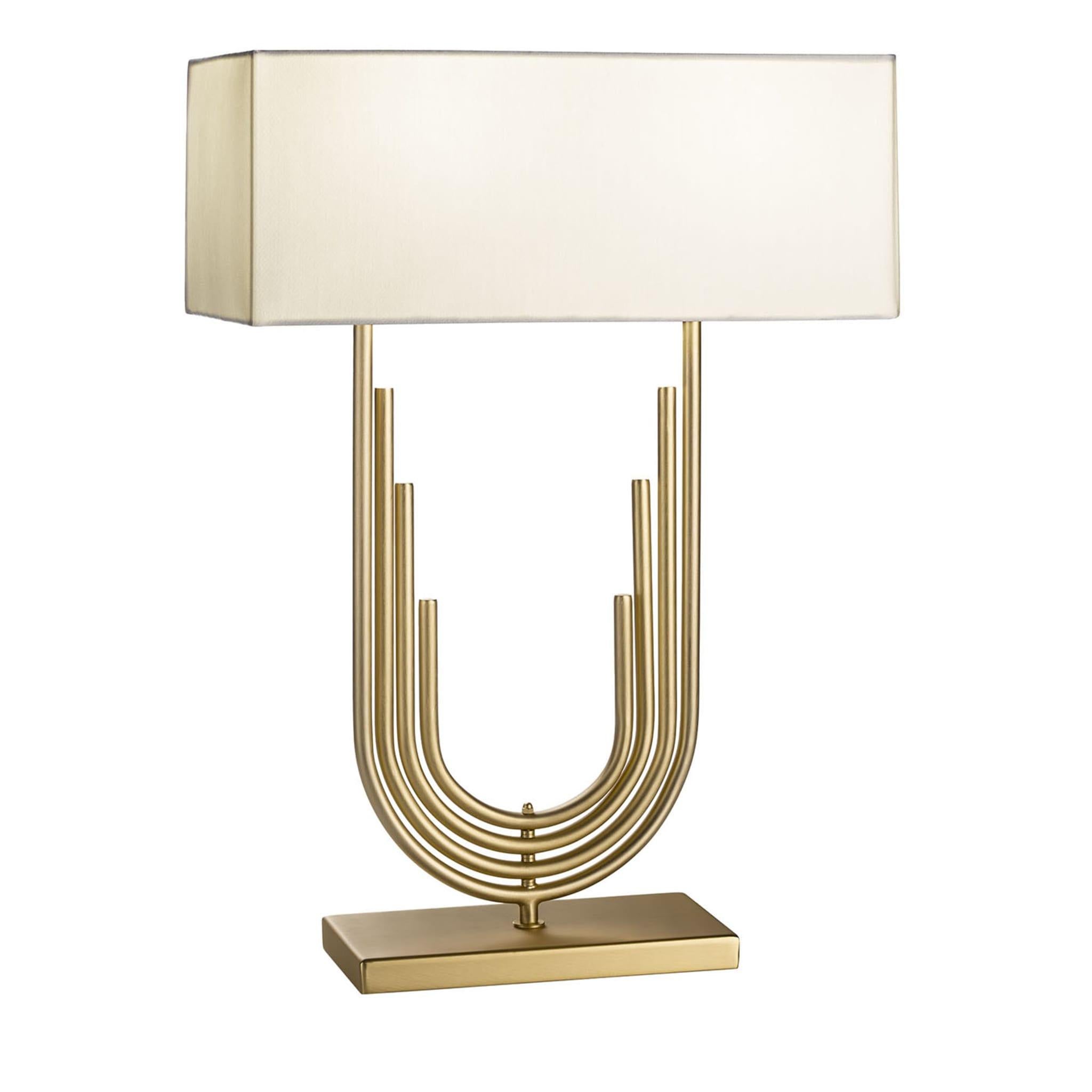 Delicacy and boldness unexpectedly coexist in this superb table lamp, its clean-lined fabric shade revealing an elegant neoclassical inspiration. Stemming from a coordinated rectangular base, the central brass body consists of a series of staggered,