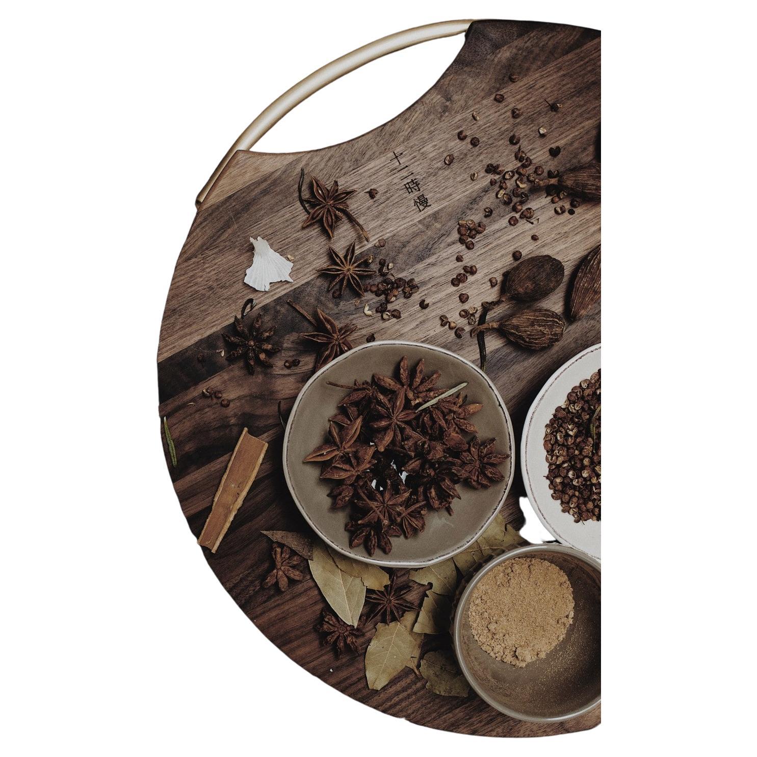 12h's Neoclassic cutting block is an essential kitchen item made with sophistication and enduring quality. Handcrafted using FAS-grade American walnut, this round and weighty chopping board is primed for heavy-duty use. Each block is unique; its