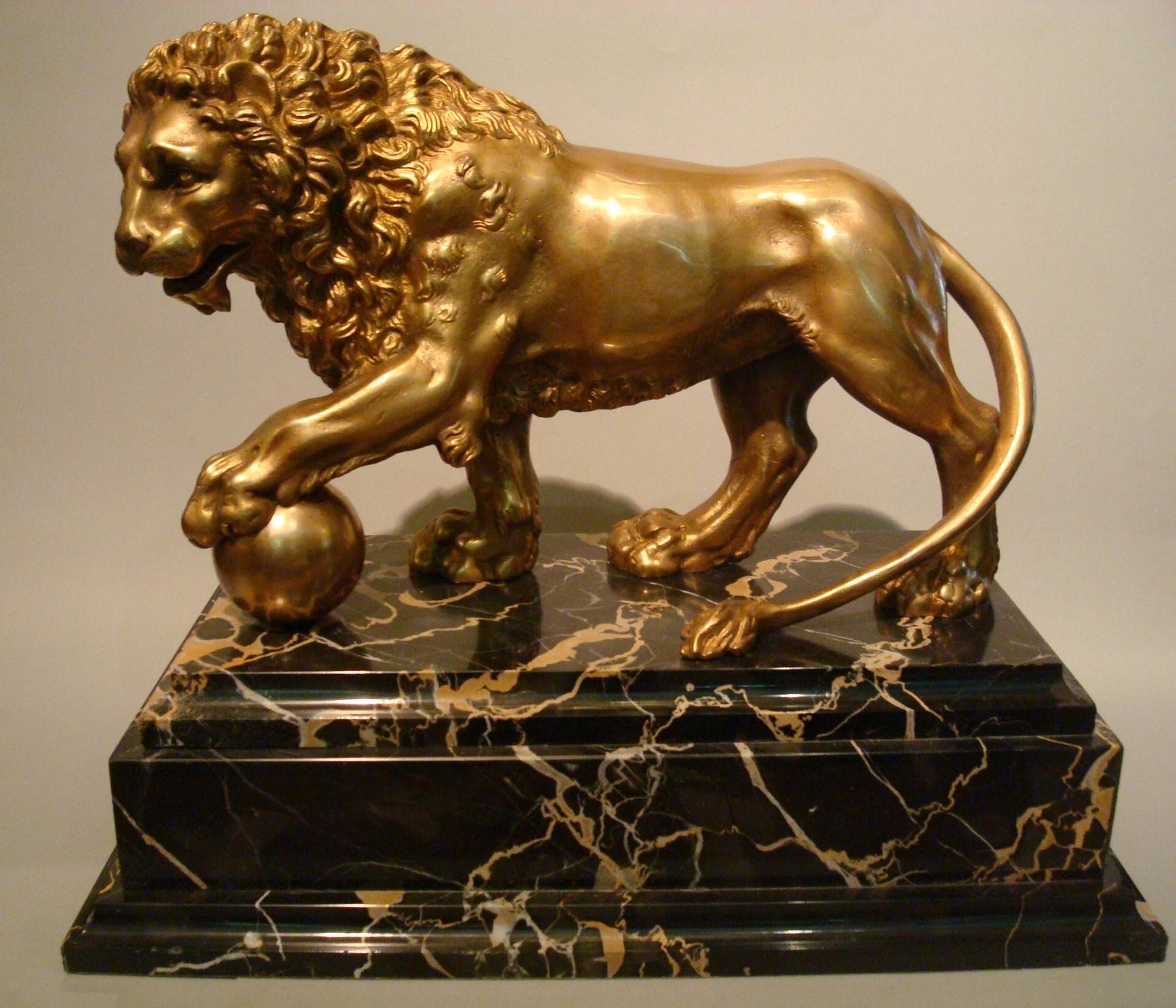An early 19th century Italian bronze lion, after the marble version carved circa 1594 by Flaminio Vacca for the Medici Villa in Rome, itself a companion to the Ancient Roman version in the Medici collection from the 1st or 2nd century AD. This