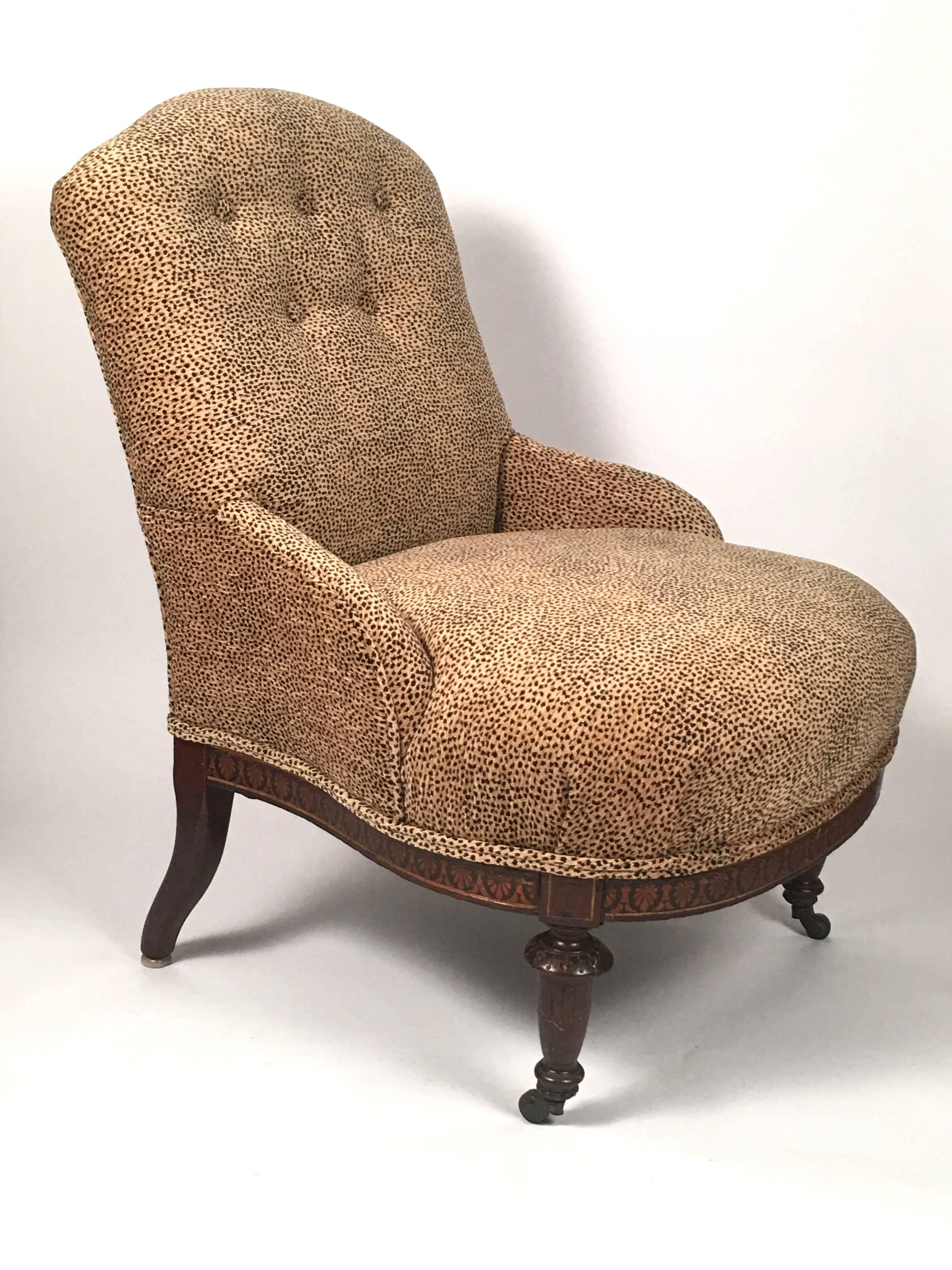 A neoclassical 19th century slipper chair, with an elaborately inlaid seat rail, decorated with anthemions, newly upholstered in a big quality leopard printed velvet, the curved, buttoned back with down swept arms over a comfortable, wide seat,