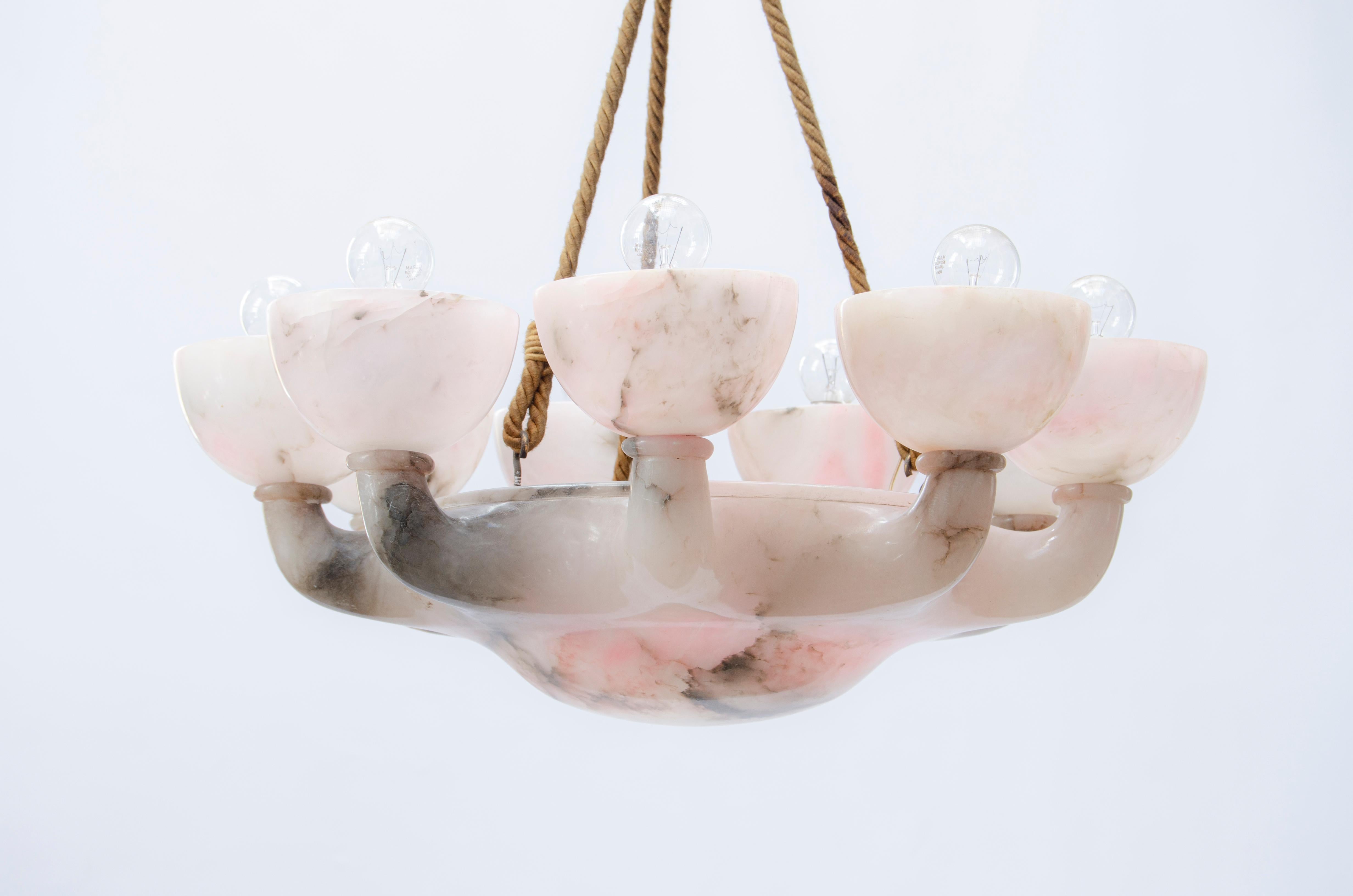 Neoclassical alabaster chandelier. Made with an alabaster frame, bronze rosette, and silk cords.

France, circa 1920.