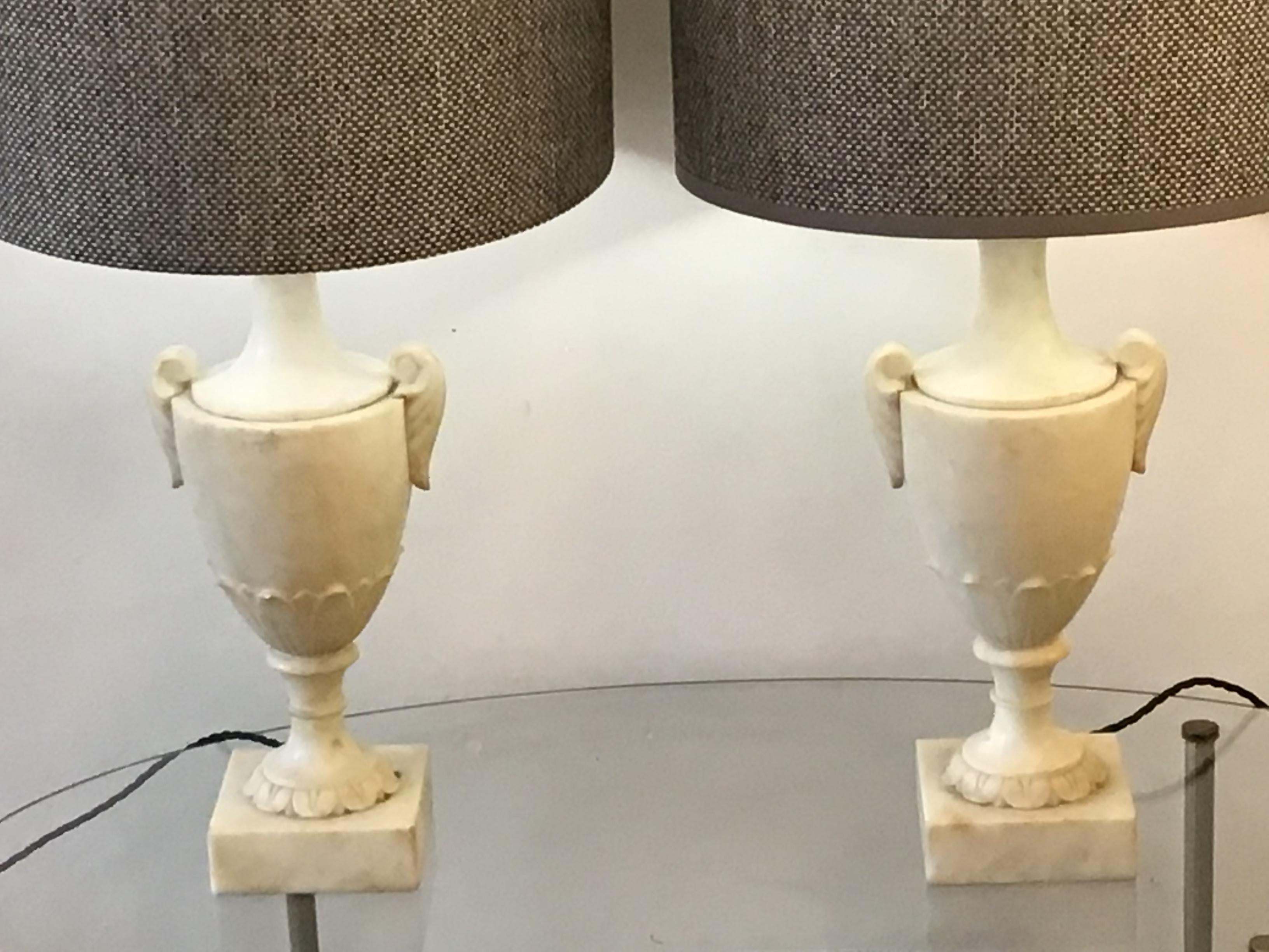 A pair of Italian alabaster lamp created in the early 20th century, The base of this Italian lamp is carved into a Classic shape re wired and tested. Cc Italian.