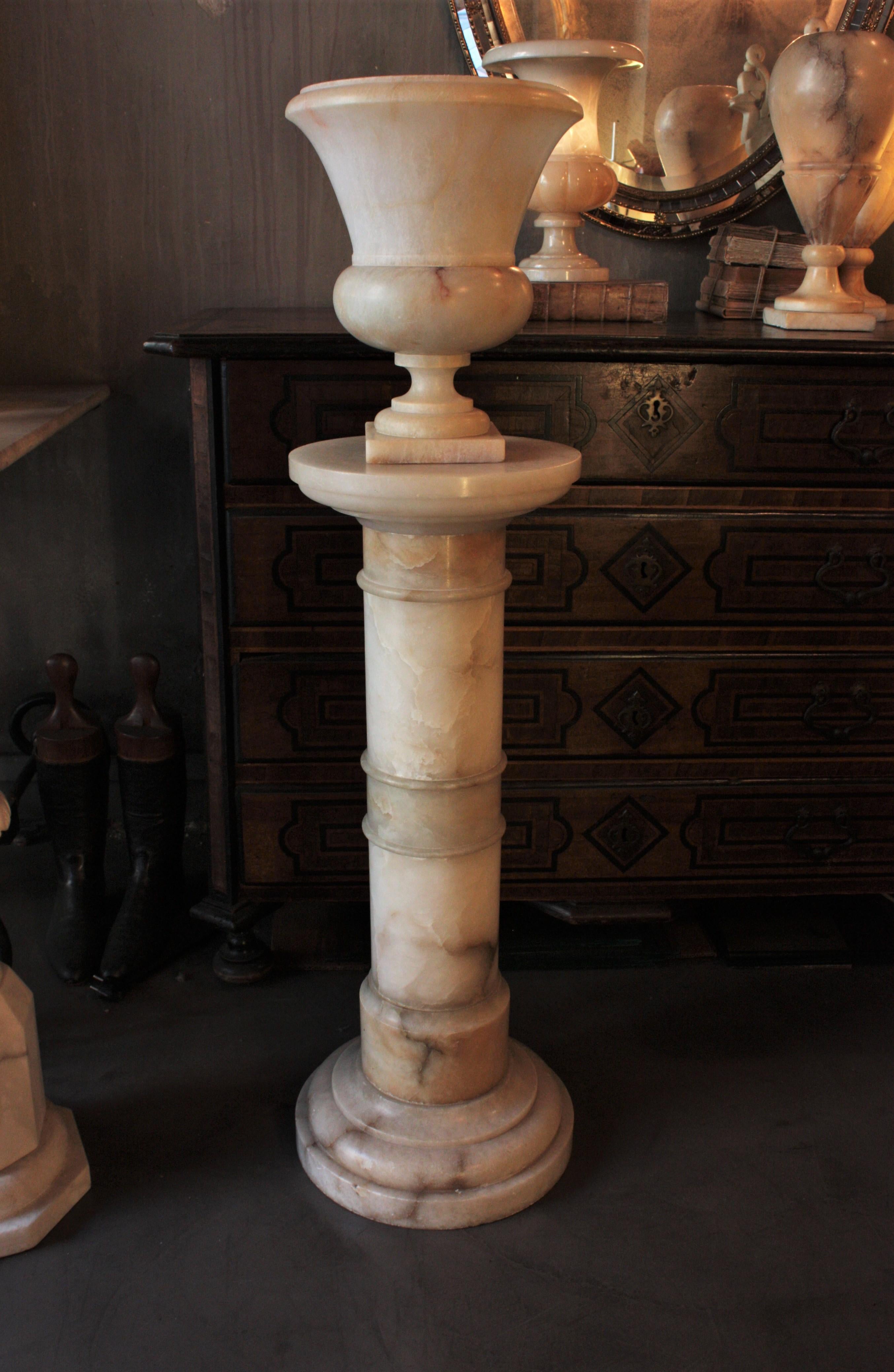 Neoclassical Alabaster Urn Lamp on Pedestal Stand

Gorgeous alabaster pedestal-mounted uplighter neoclassical urn lamp. Italy, 1940s.
Amazing aged patina, it provides a charming light and it has an stunning appearance when lit.
The pedestal and the