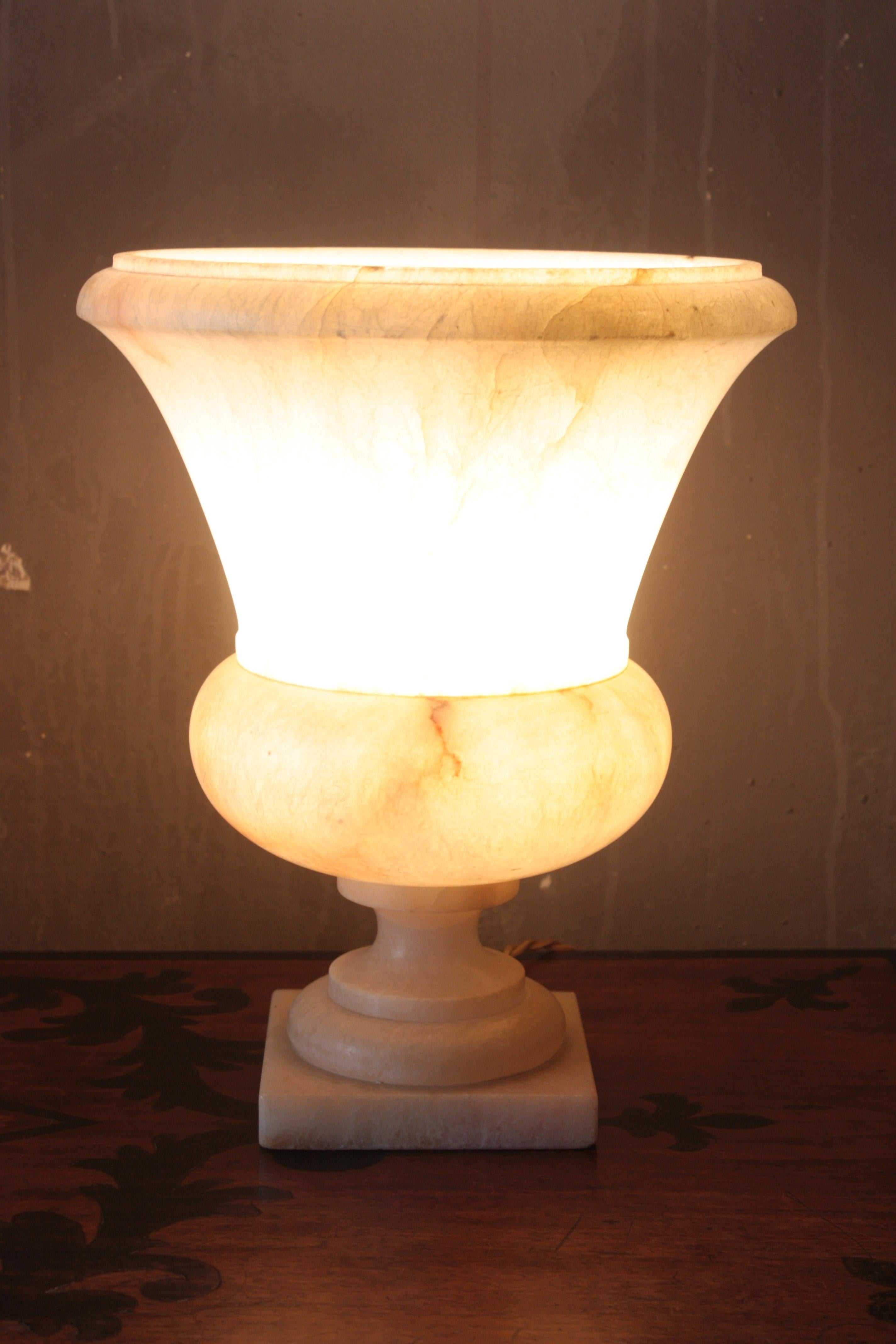Sculptural alabaster Art Deco period urn table lamp with neoclassical design, Italy, 1940s.
This elegant carved alabaster neoclassical 'uplighter' urn lamp will be a nice addition placed in a console table or side table or standing on a column