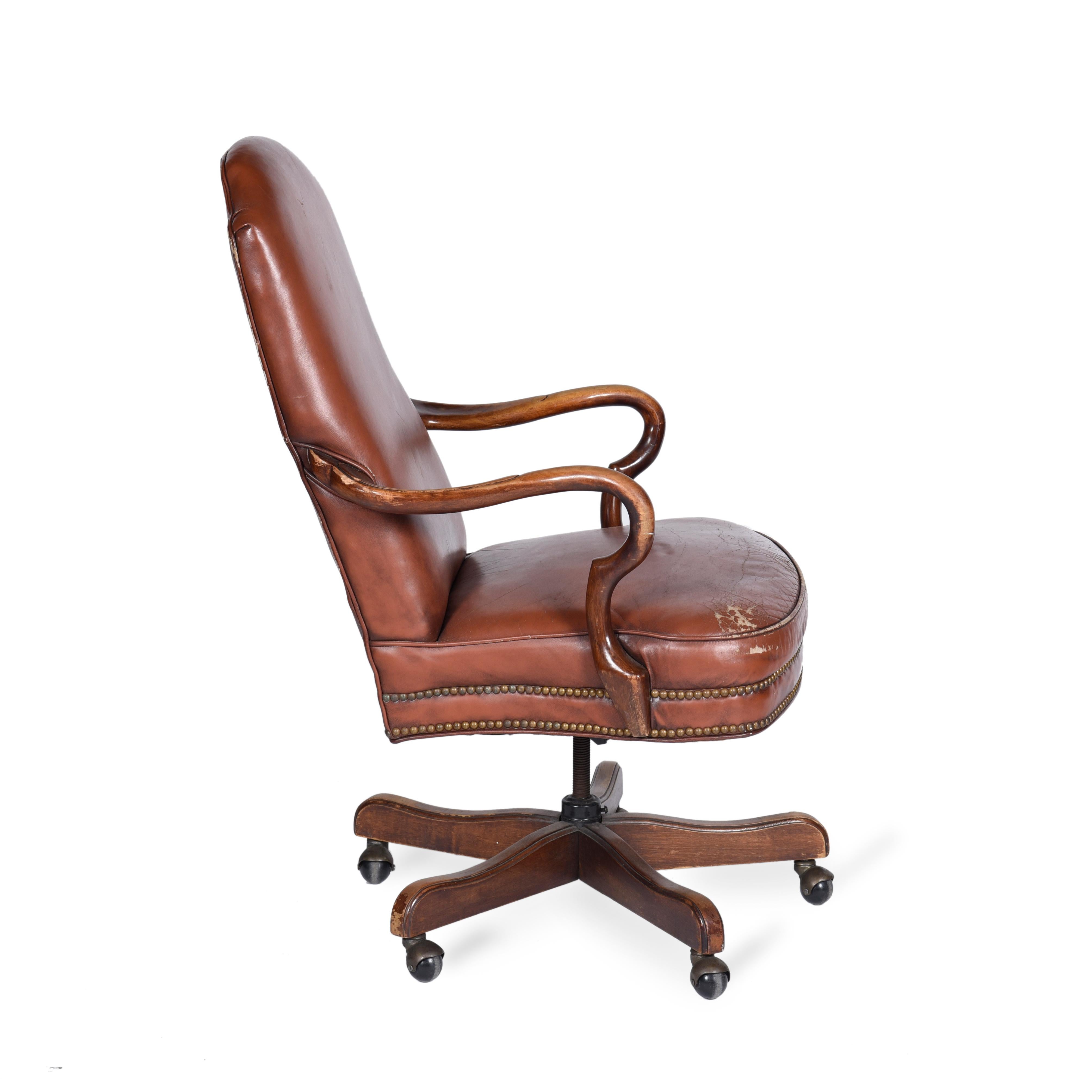 Neoclassical American rotating leather office chair by Woodmark.
  