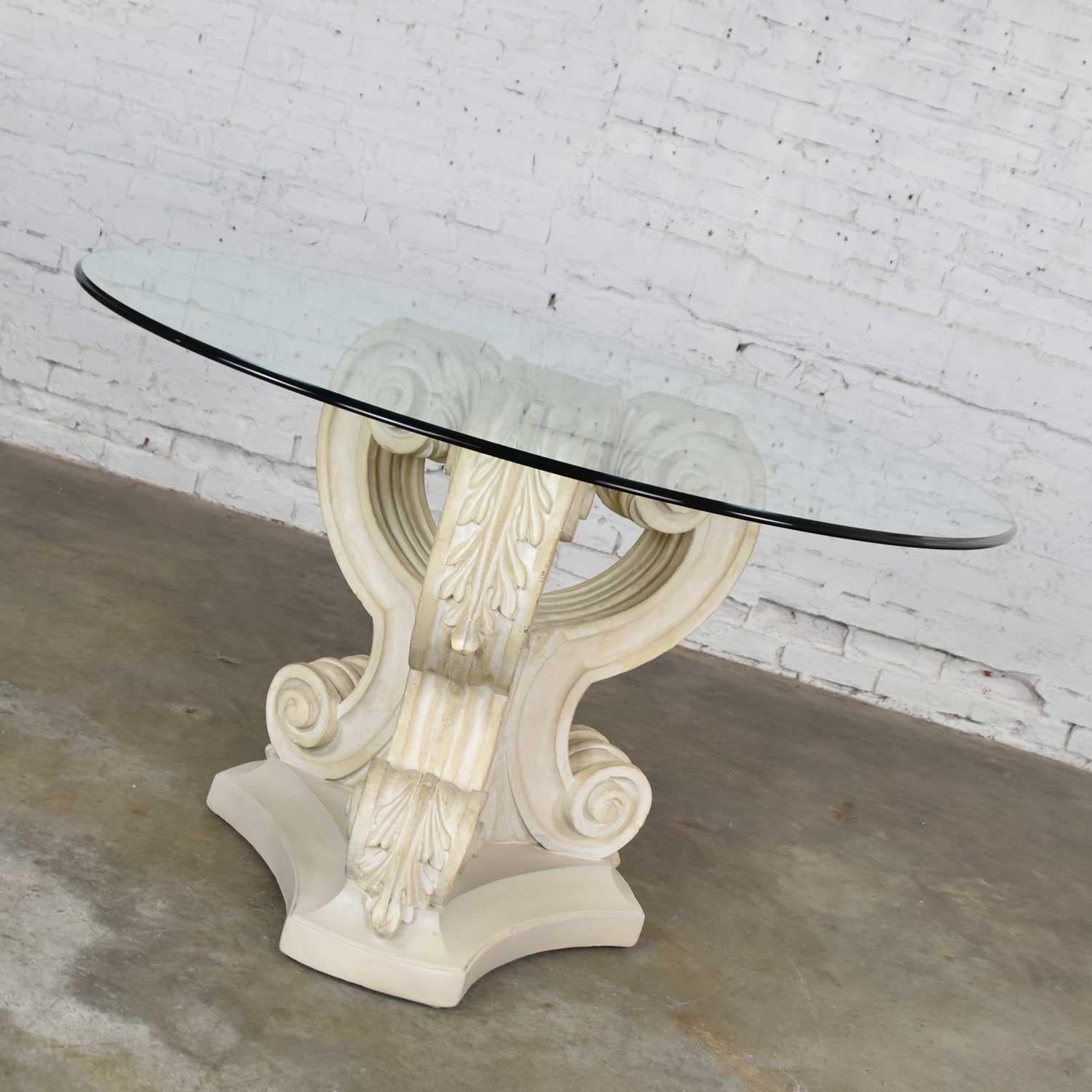 Gorgeous neoclassical style architectural plaster pedestal base dining table or center table with a 48-inch round glass top with ogee edge. It is in wonderful vintage condition. There is a damaged spot on the plaster which has been restored. You