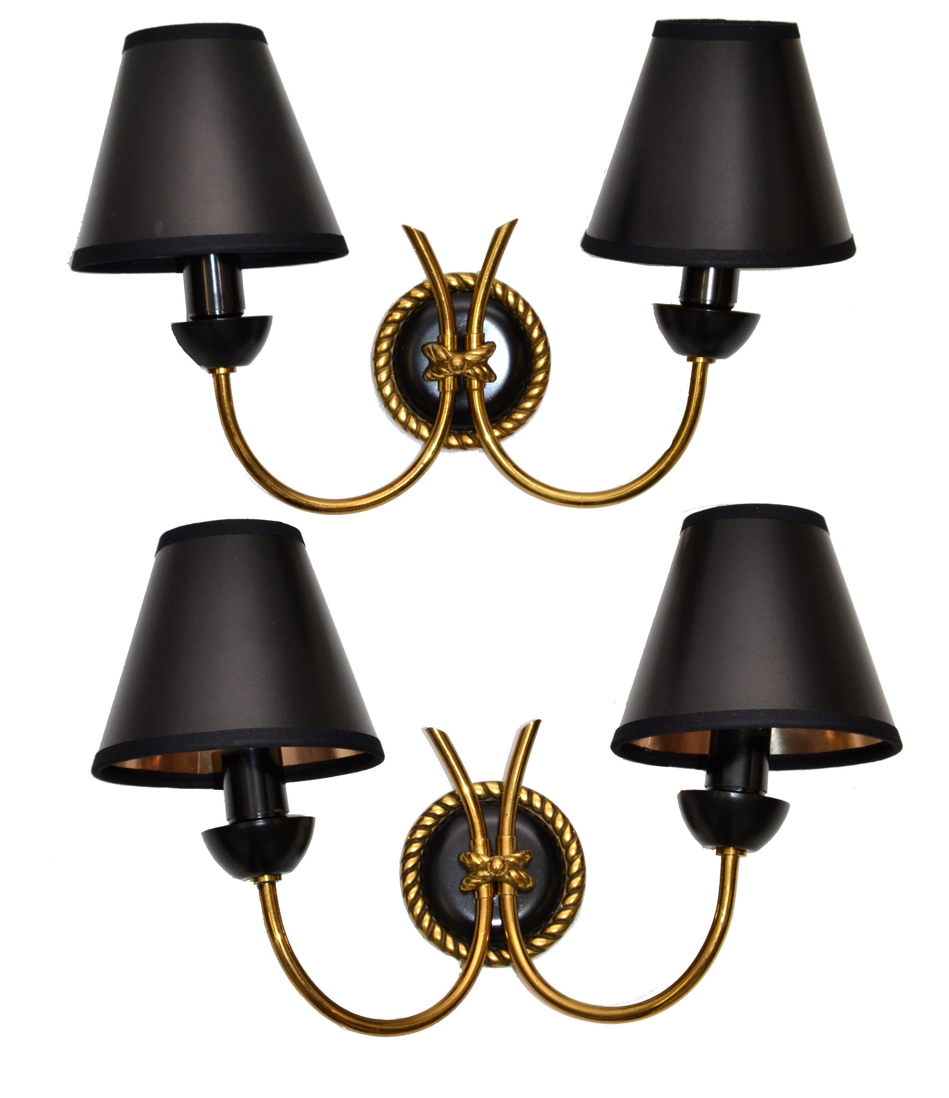 Elegant neoclassical pair of sconces, wall lamps in brass & gun metal by Maison Arlus, made in France.
The set comes with black and gold paper shades.
US Rewiring and each Sconce takes 2 light bulbs with max 40 watts, LED work too.
Back Plate