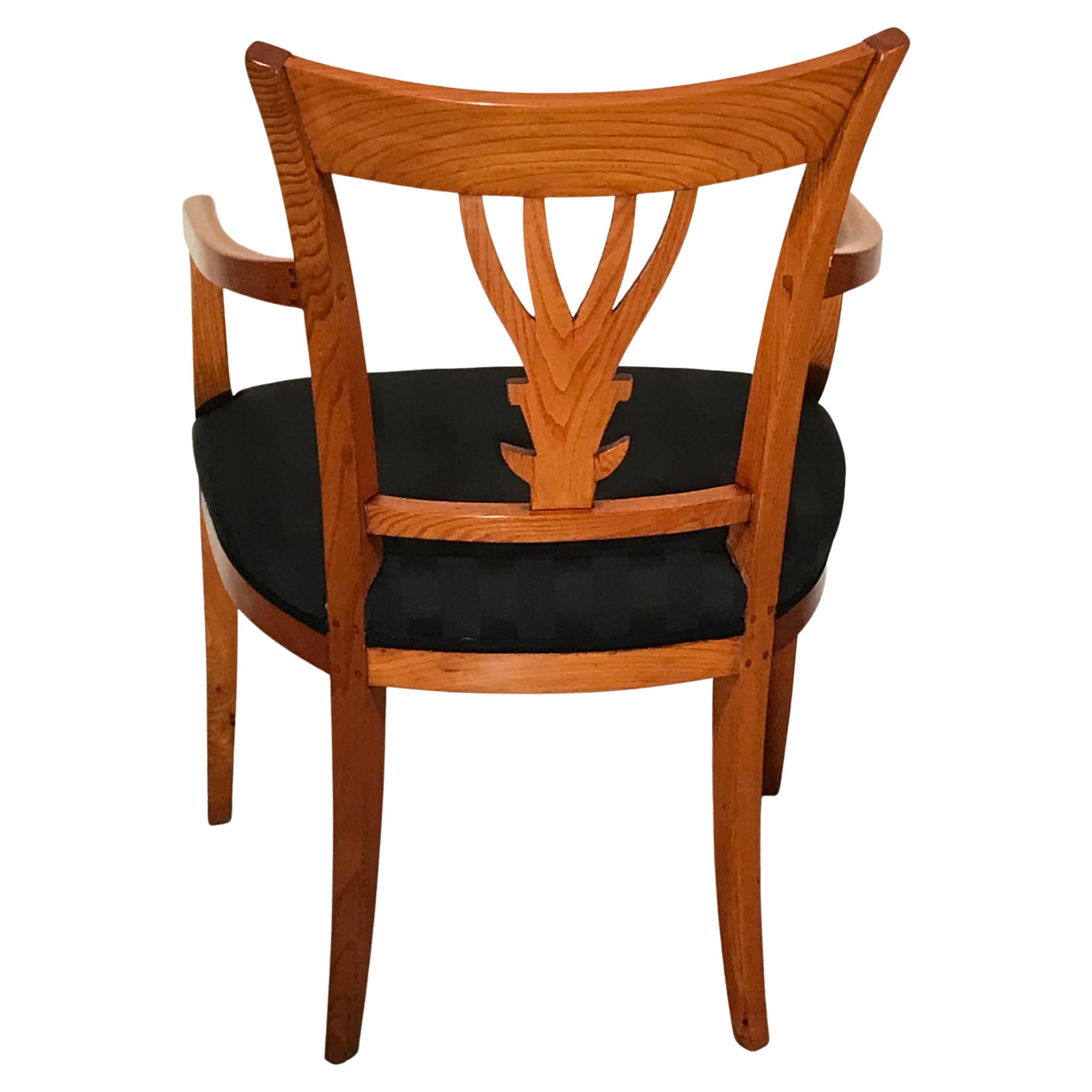 Beautifully designed neoclassical armchair dating back to around 1810-30. The chair comes from Southwest Germany. The back has a very pretty open work design with a hand carved leave design. The armchair is refinished and has a new upholstery and is