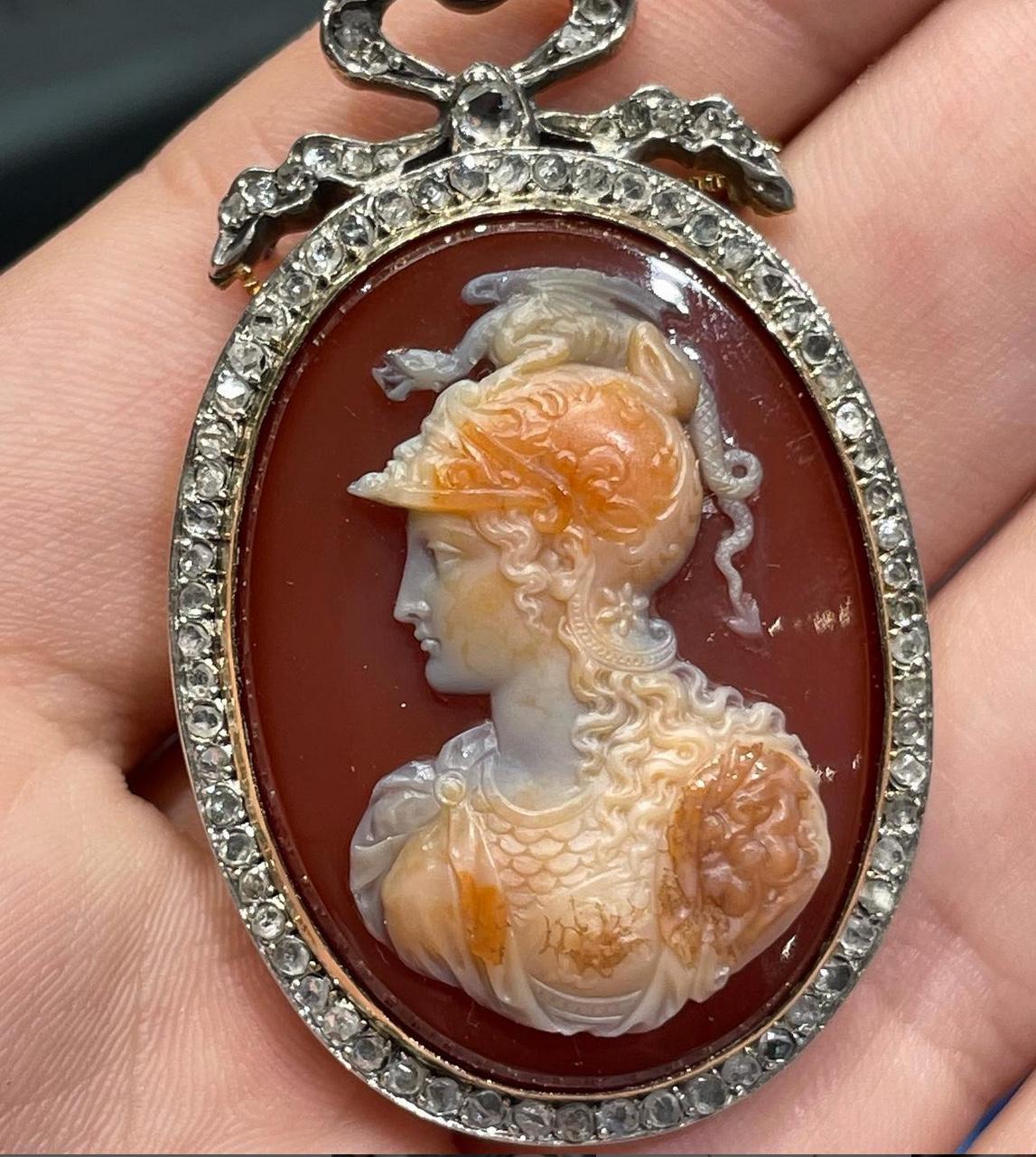 A sardonyx neoclassical cameo in two strata, set in a silver and gold frame with ribbon pendant, depicting a bust of Minerva, Italy, c.1780. Minerva, Goddess of war, known as Pallas Athena in Greek mythology, was one of the major deities, the