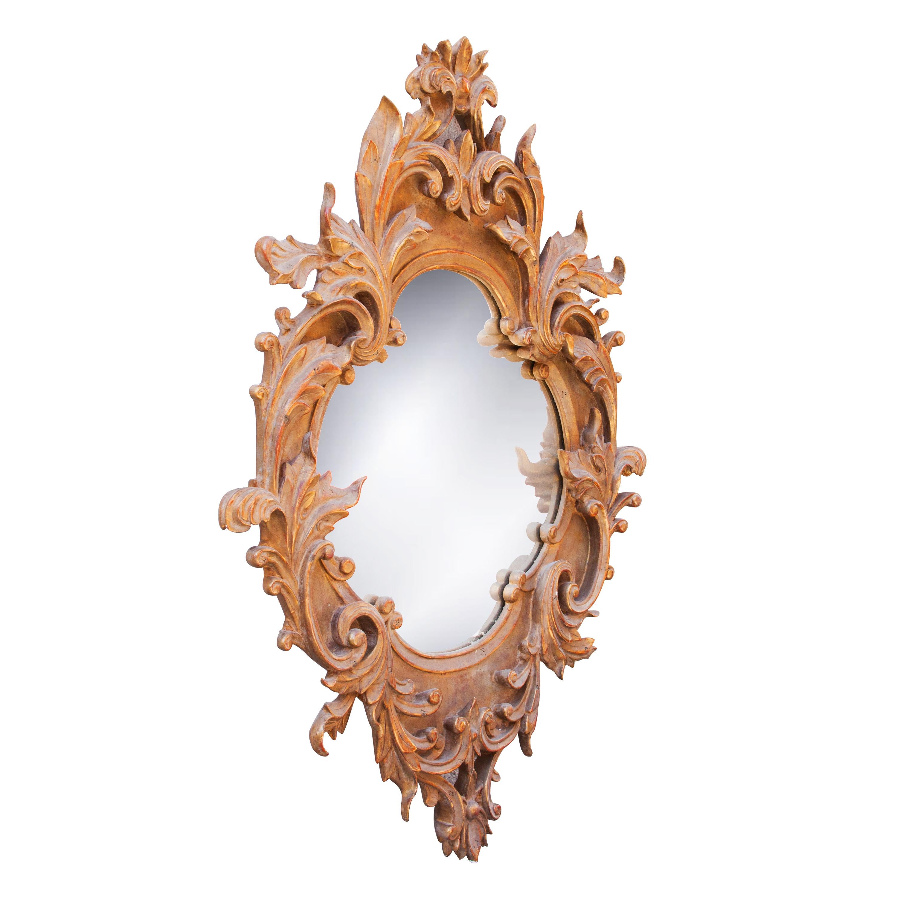 Neoclassical baroque style handcrafted mirror. Acanthus leaf shaped. Hand carved wooden structure with gold foil finished, Spain, 1970.