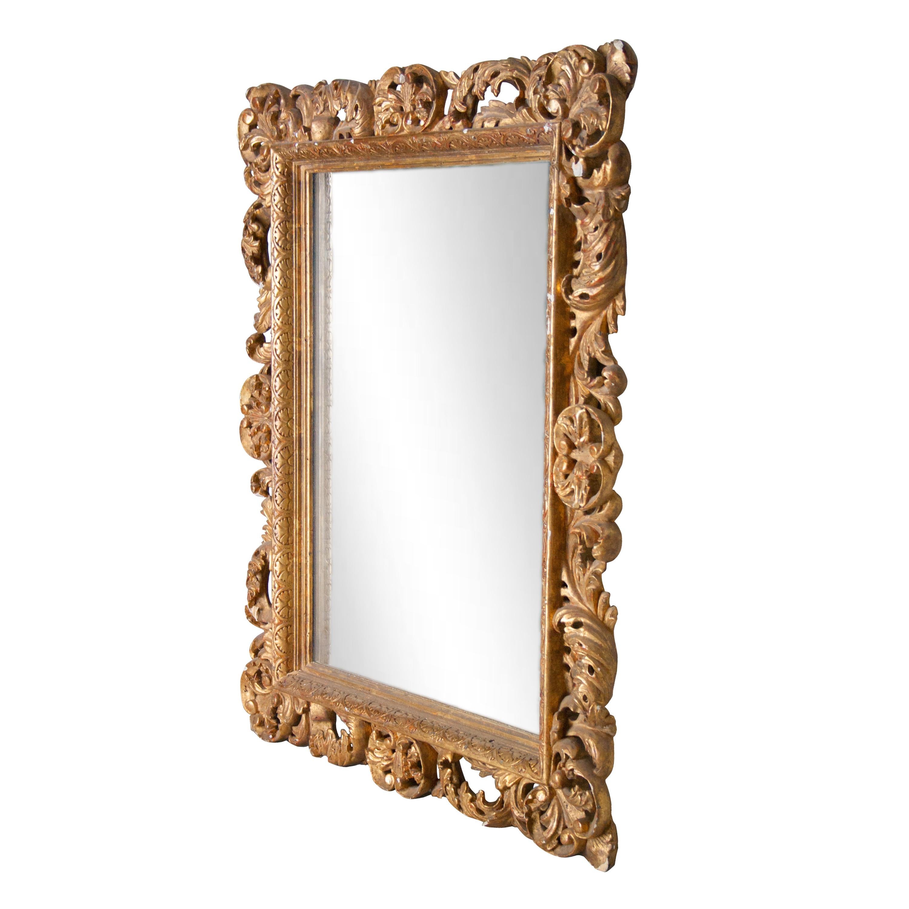 Neoclassical baroque style handcrafted mirror. Hand carved wooden structure with gold foil finished, Spain, 1970.