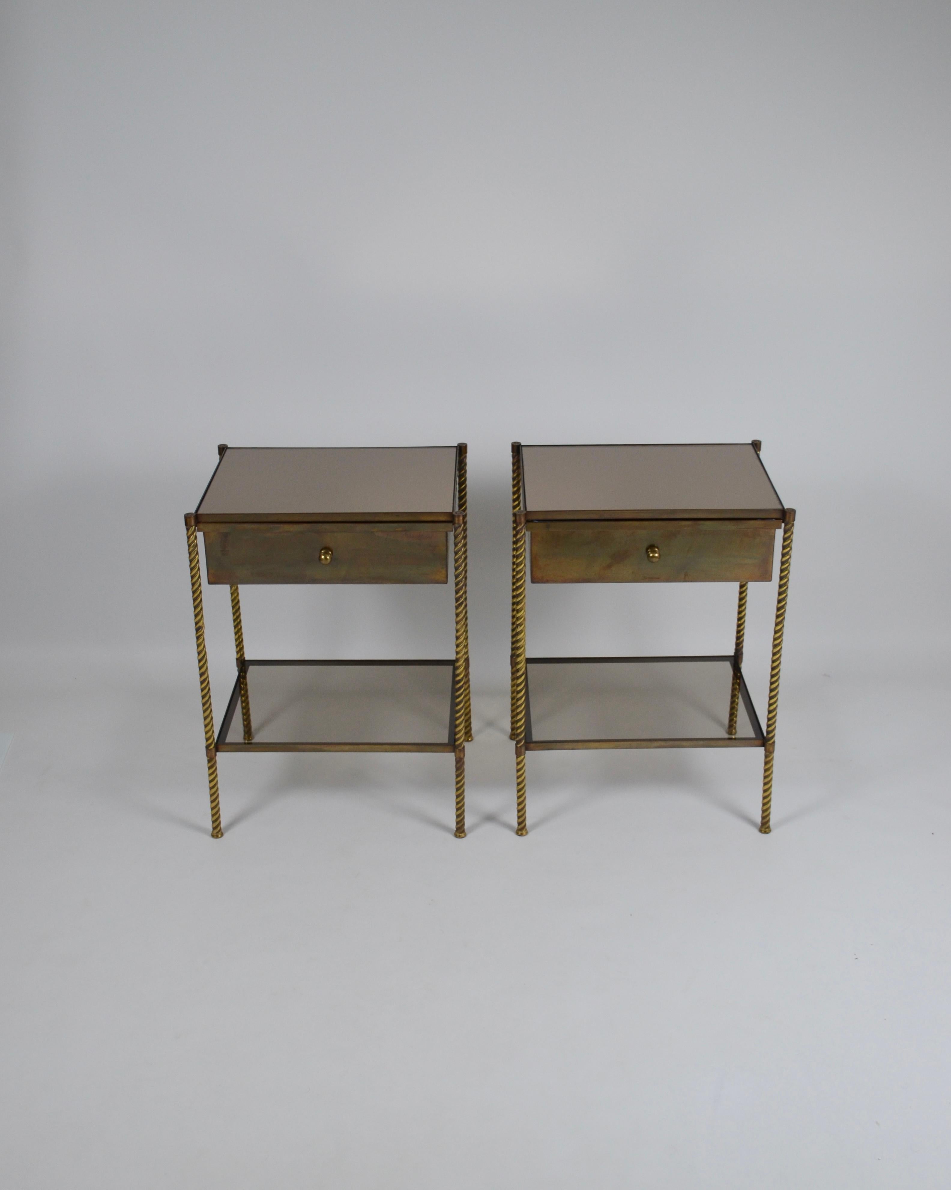 Pair of neoclassical nightstands/end tables in the style of the Maison Jansen or Bagués, France, 1950s/60s.
Brass structure with beautiful patina, composed of 4 fine columns nicely worked and detailed.
Each table has a drawer lined inside with