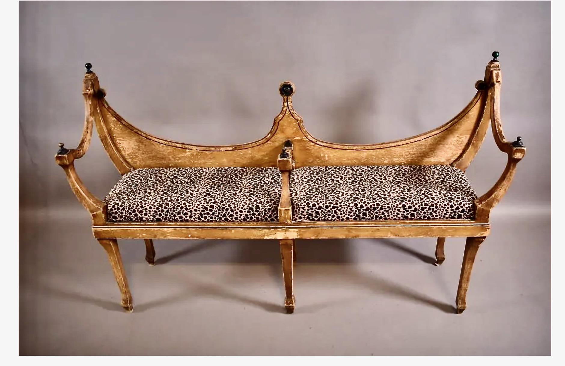 This is an unusual form of neoclassical bench that dates to the early 19th century. The original painted surface has been retained and is richly patinated. The unique bench would had spark to any interior.