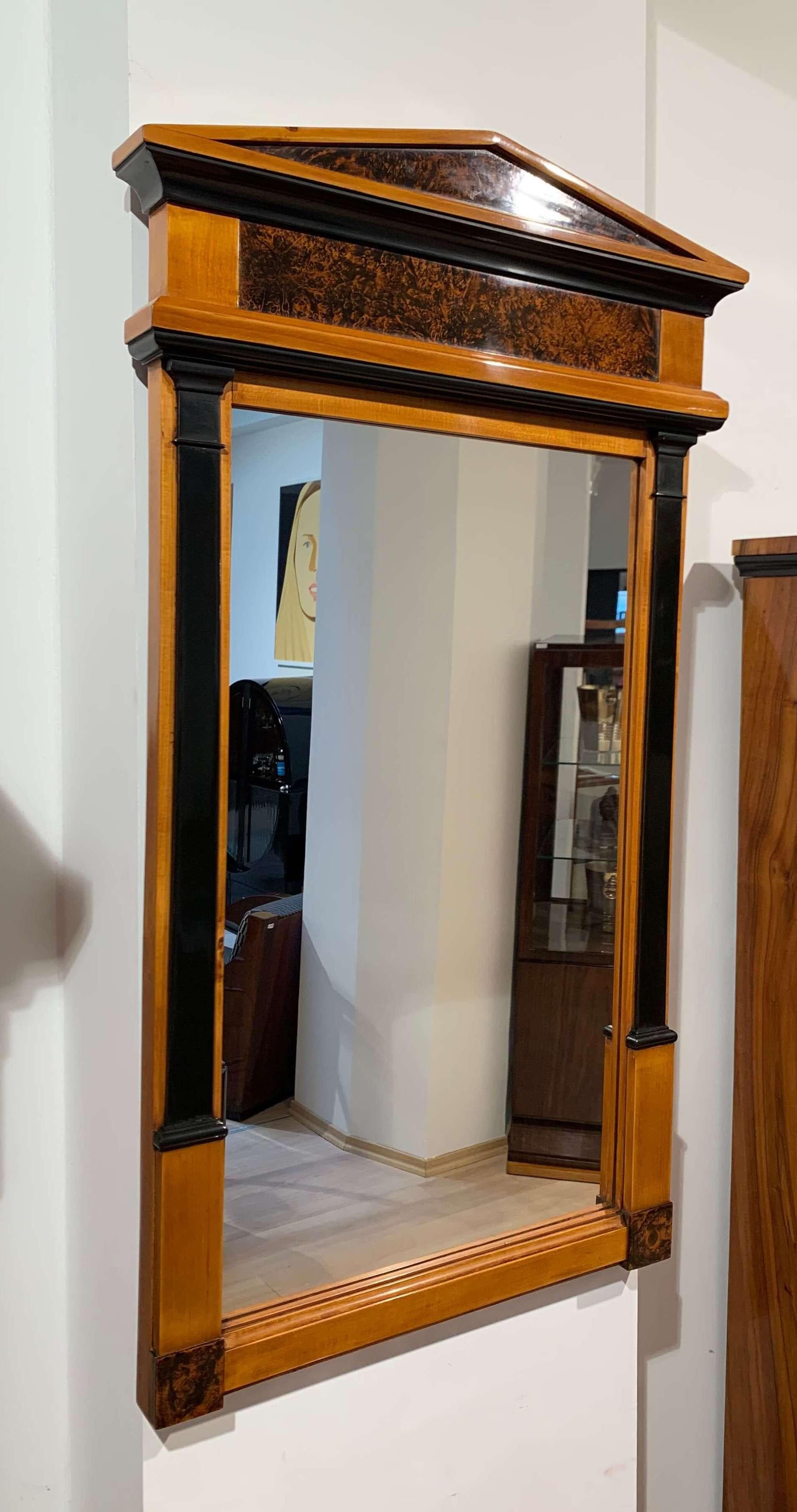 Beautiful neoclassical, strict and early Biedermeier wall mirror from South Germany, circa 1820.

Cherry solid wood, partly ebonized and dark walnut roots. All the wood has been hand polished with shellac (French polished).
Lovely stirct